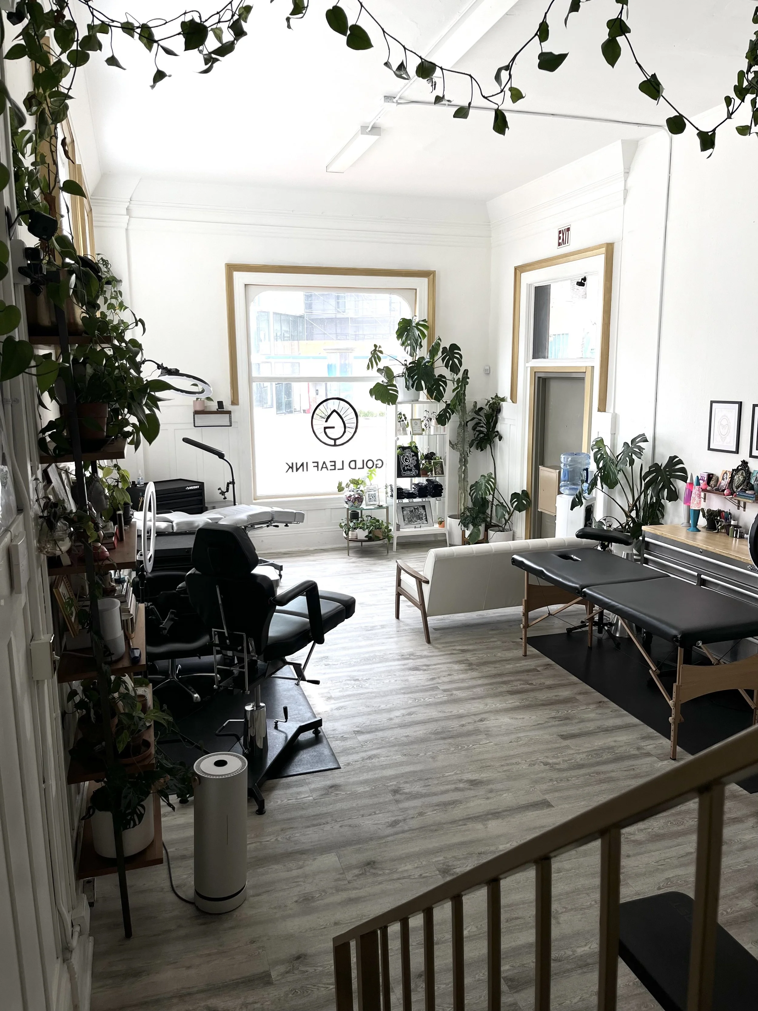 Photo of the studio space, Gold Leaf Ink. The studio is bright with natural light, minimally decorated, and filled with plants.