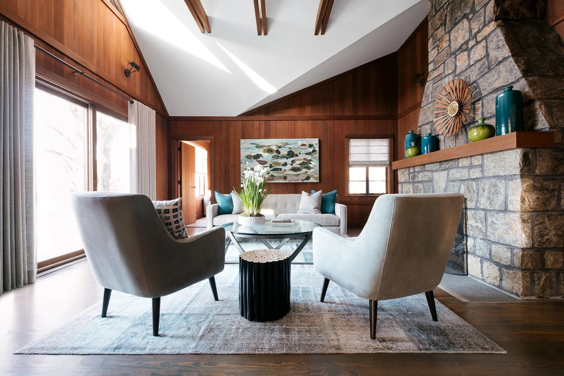 Bright lake house living room in Putnam County, New York, featuring expansive windows, natural light, and warm, contemporary furnishings.