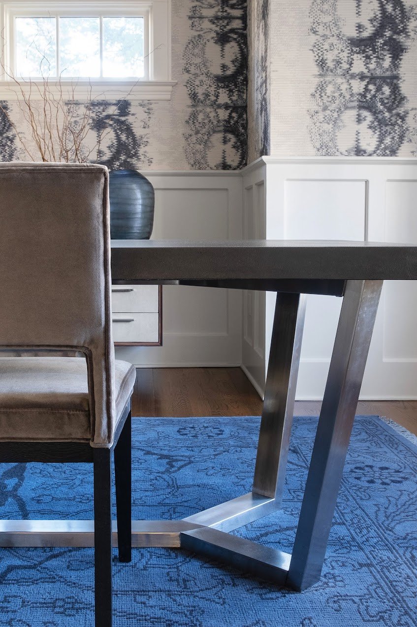 A vintage wool rug, shagreen buffet, and modern velvet dining chairs combine with Arte wallpaper and classic architecture in this dining room design