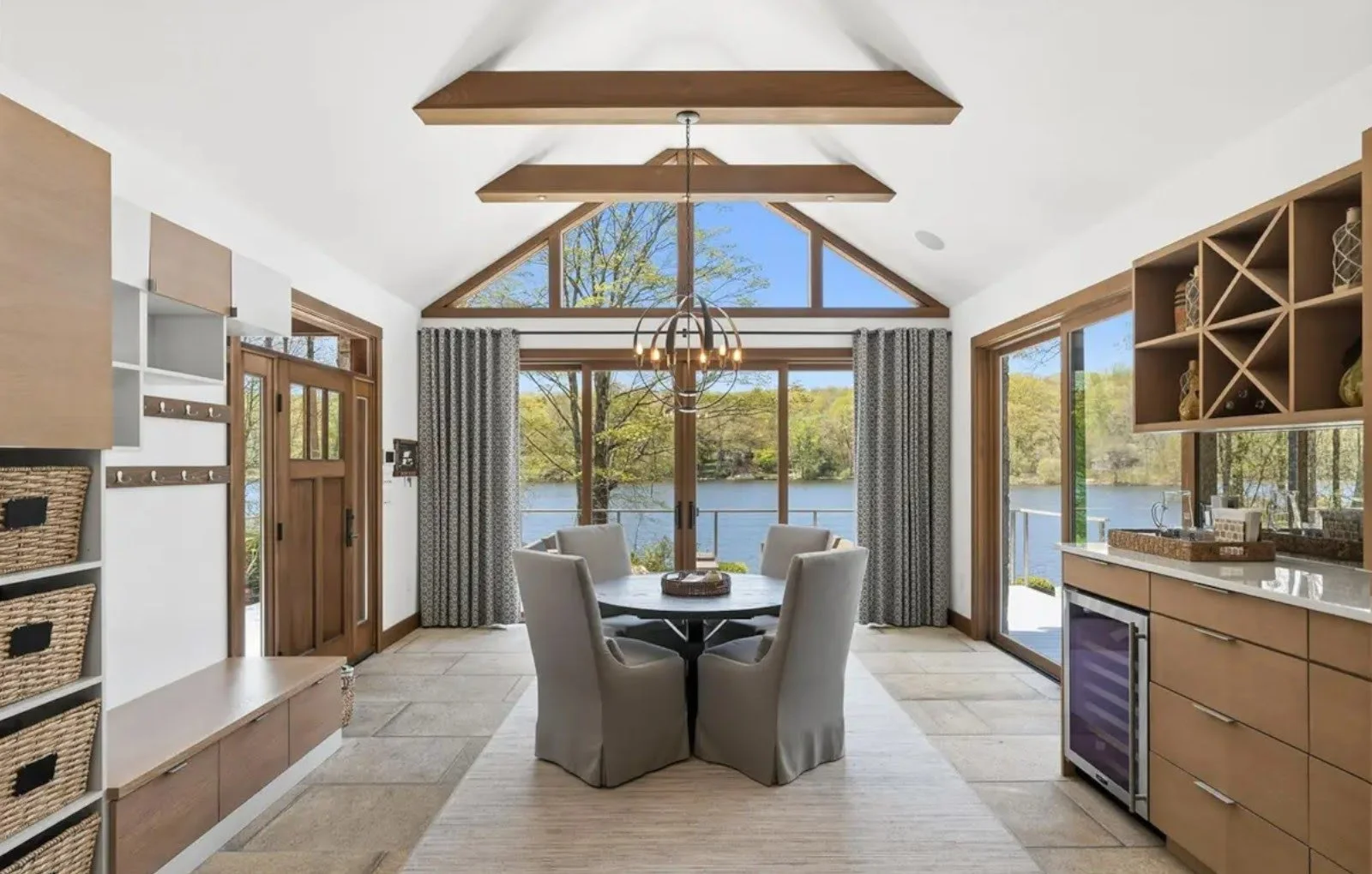 Dining room addition for a Putnam Valley lake house designed to connect the interior with the surrounding landscape through vaulted ceilings, abundant natural light, and warm, natural materials.