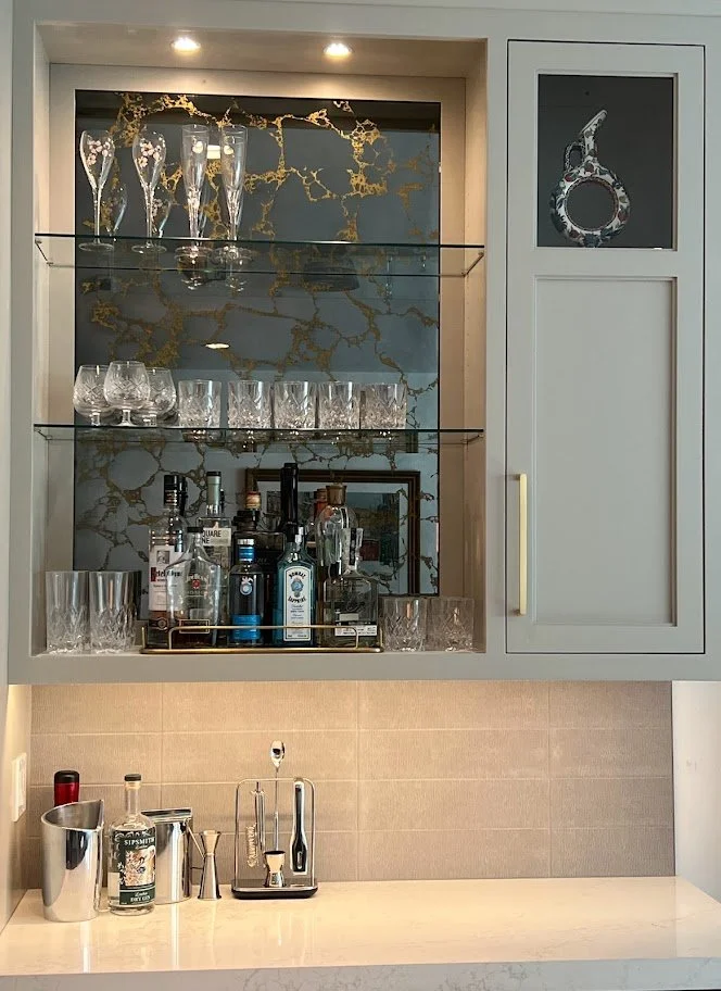 Custom cabinetry design by Spice Hill Interiors featuring bar area with antique mirror inset in Bronxville, Westchester County