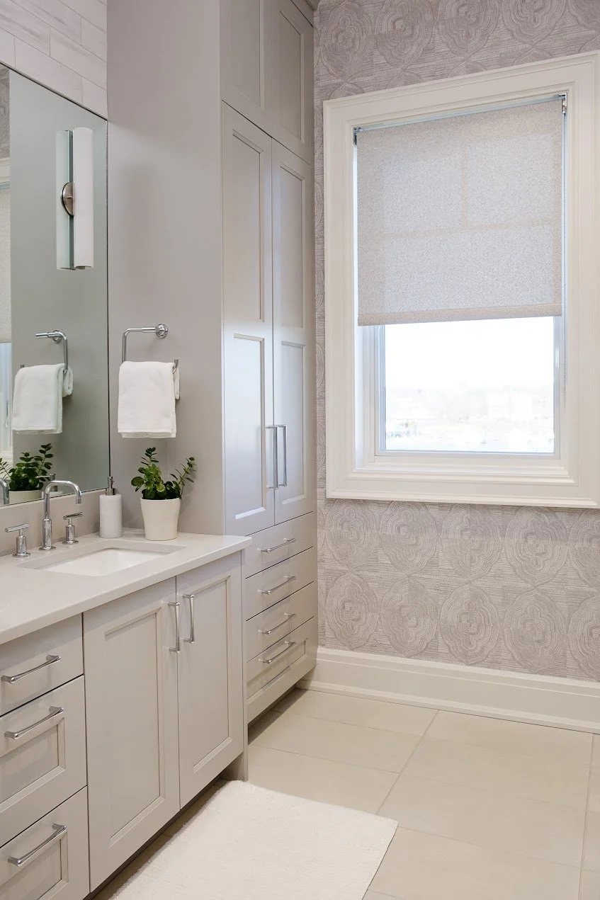 A soft palette and textured wallpaper provide comfortable amenities for the homeowners