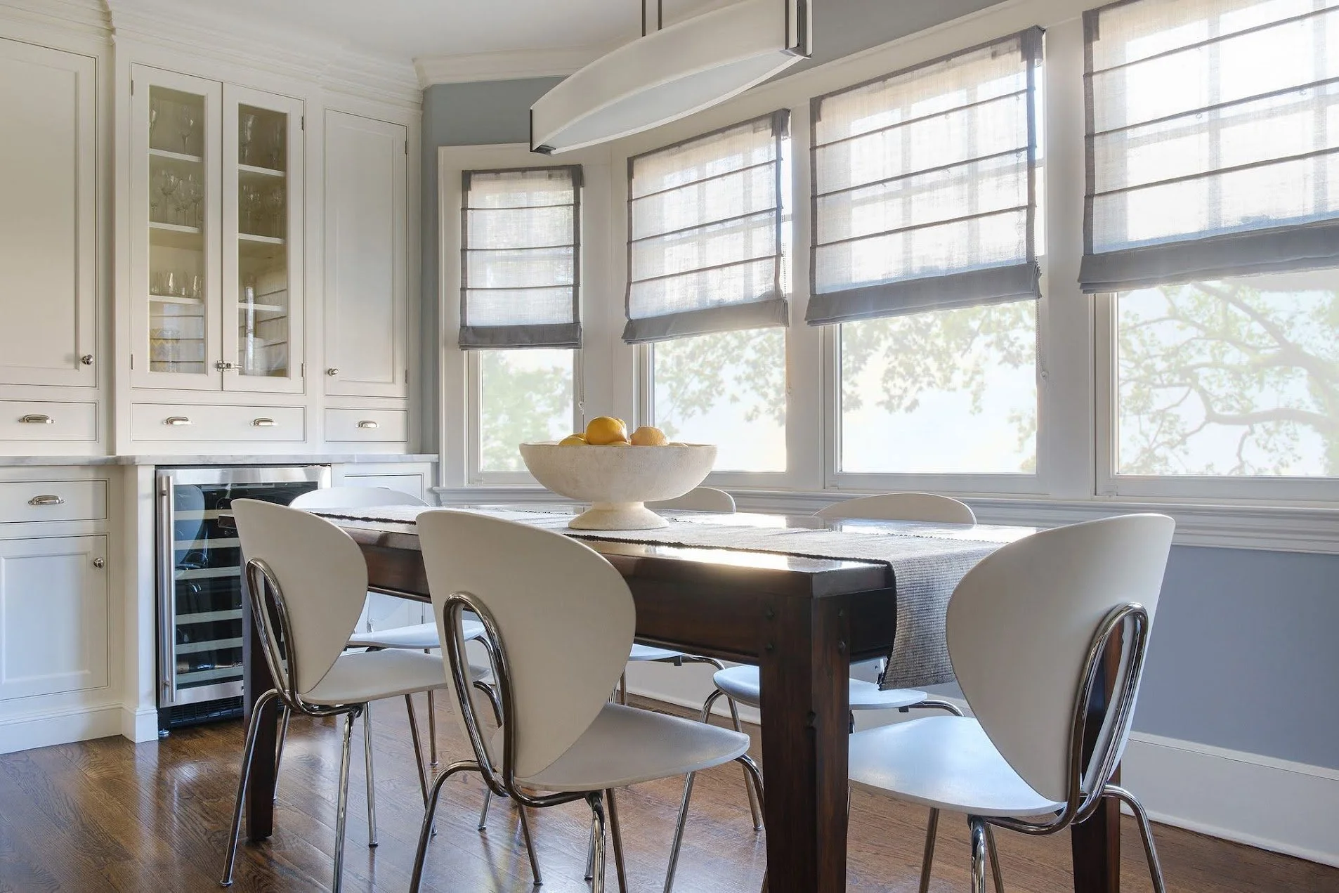 Custom sheer relaxed Roman shades in the dining room of a Larchmont Colonial home.