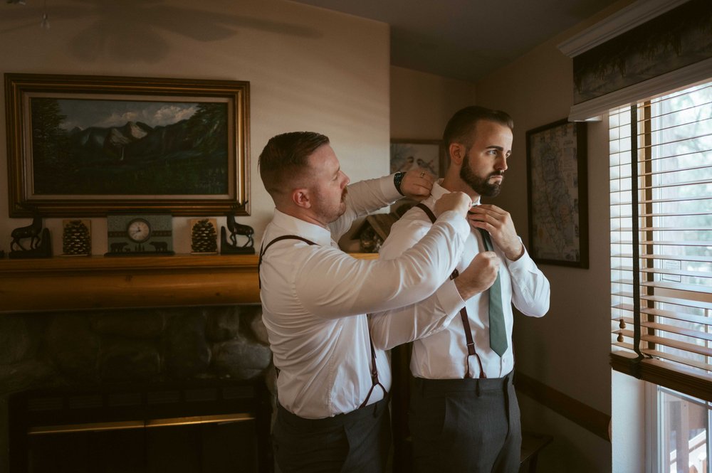 wedding groom putting on tie yosemite