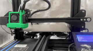 GIF of 3d printing a green plastic rocket