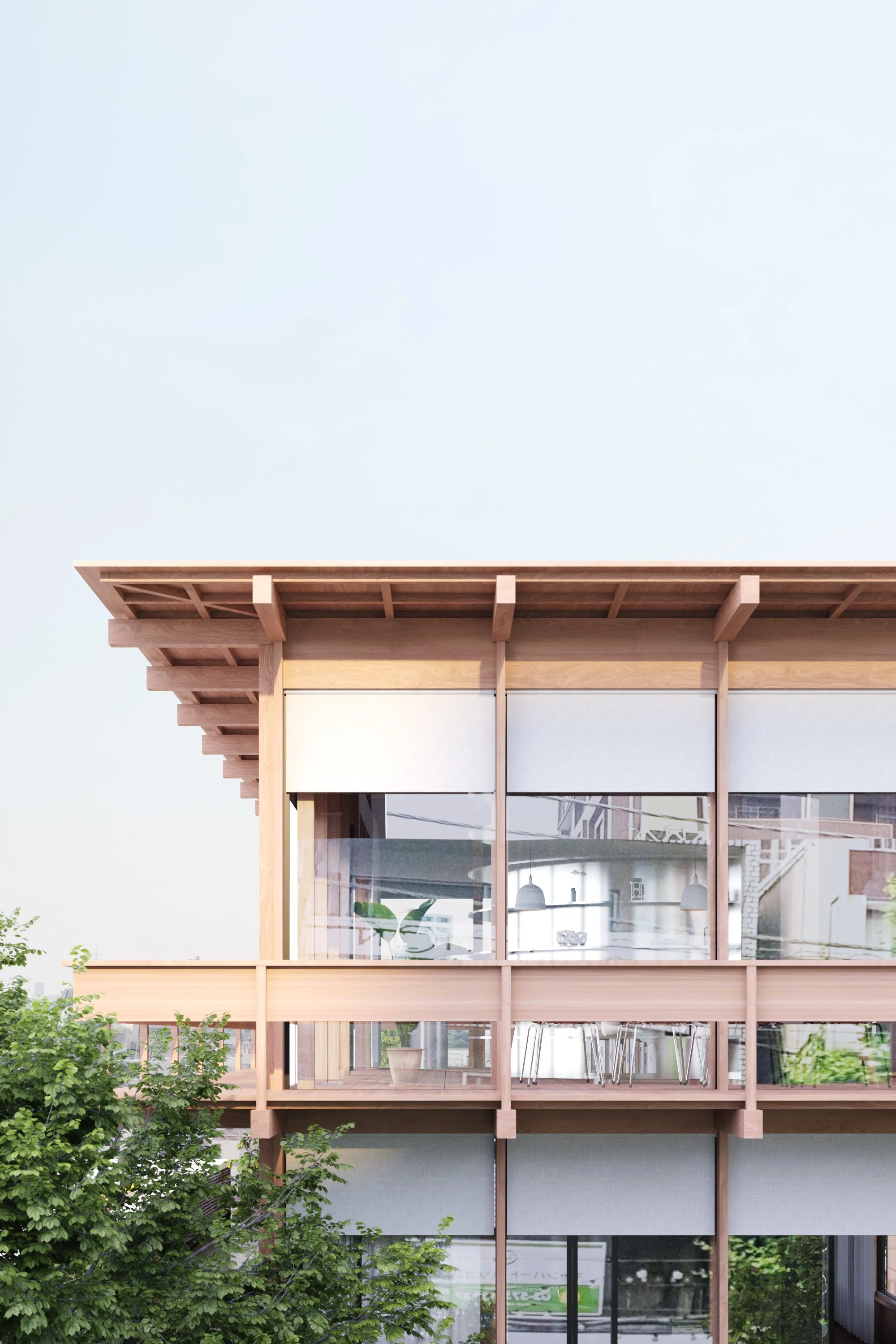 Modern wooden building with large glass windows, surrounded by green trees, and a clear sky in the background.