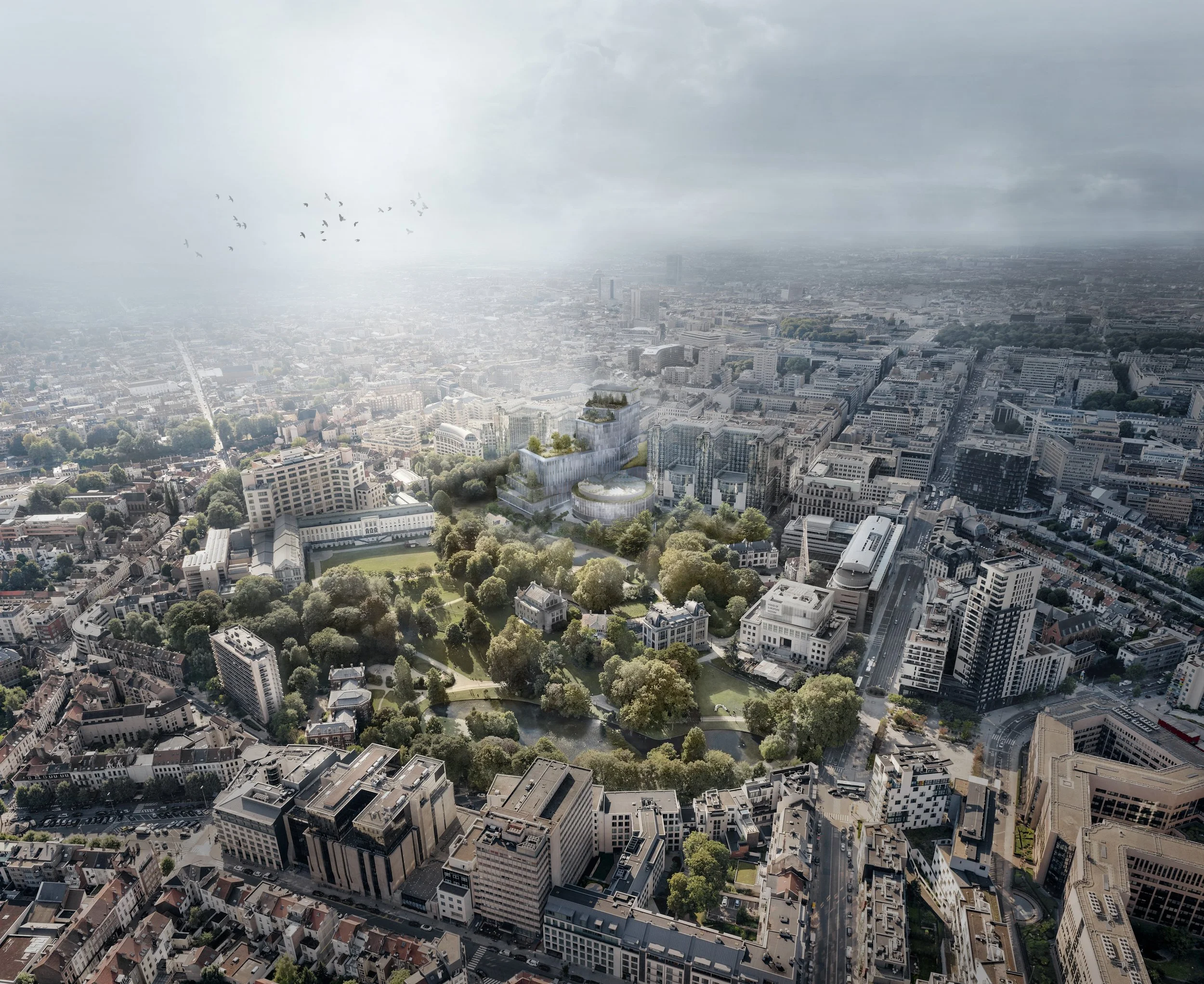 Aerial view of a cityscape with numerous buildings, roads, and green spaces under a cloudy sky, with a flock of birds flying in the distance.