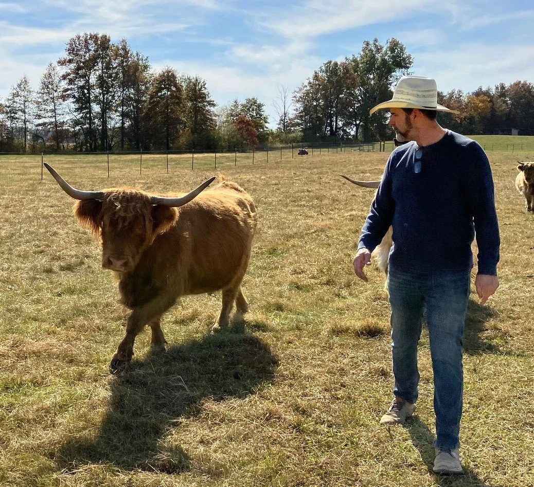 Russ walking with his first Highland Cow, Skye.  She is amazing and still part of our farm.