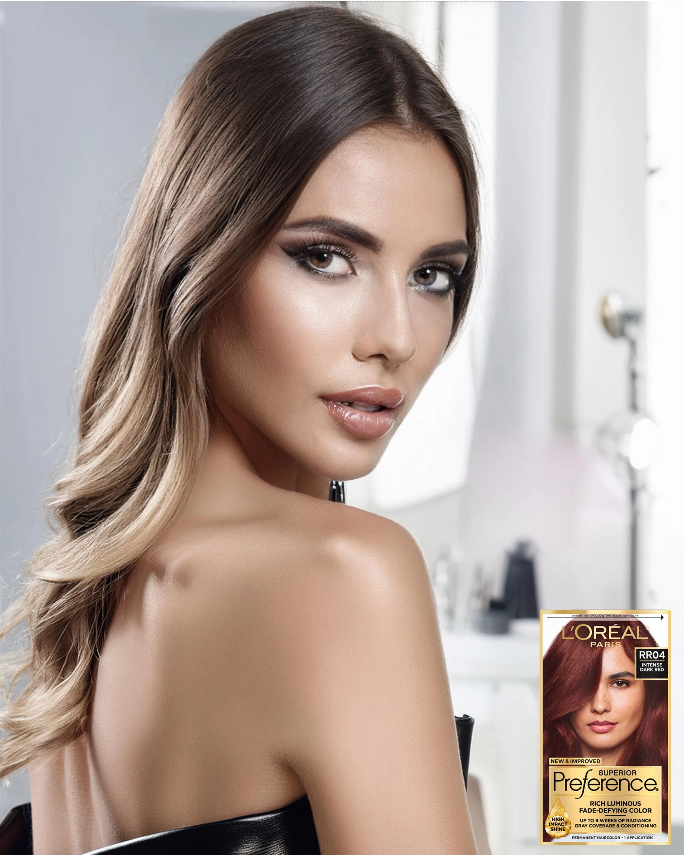 A woman with long, wavy, light brown hair with blonde highlights, wearing makeup, looking at the camera with her shoulder bare. In the background, there is a box of L'Oreal Preference hair dye color RRD4, Dark Red.