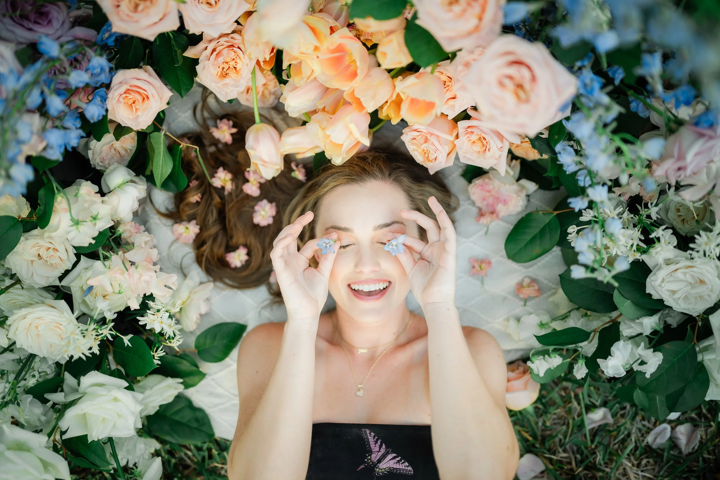 Young model holding flowers in flower field