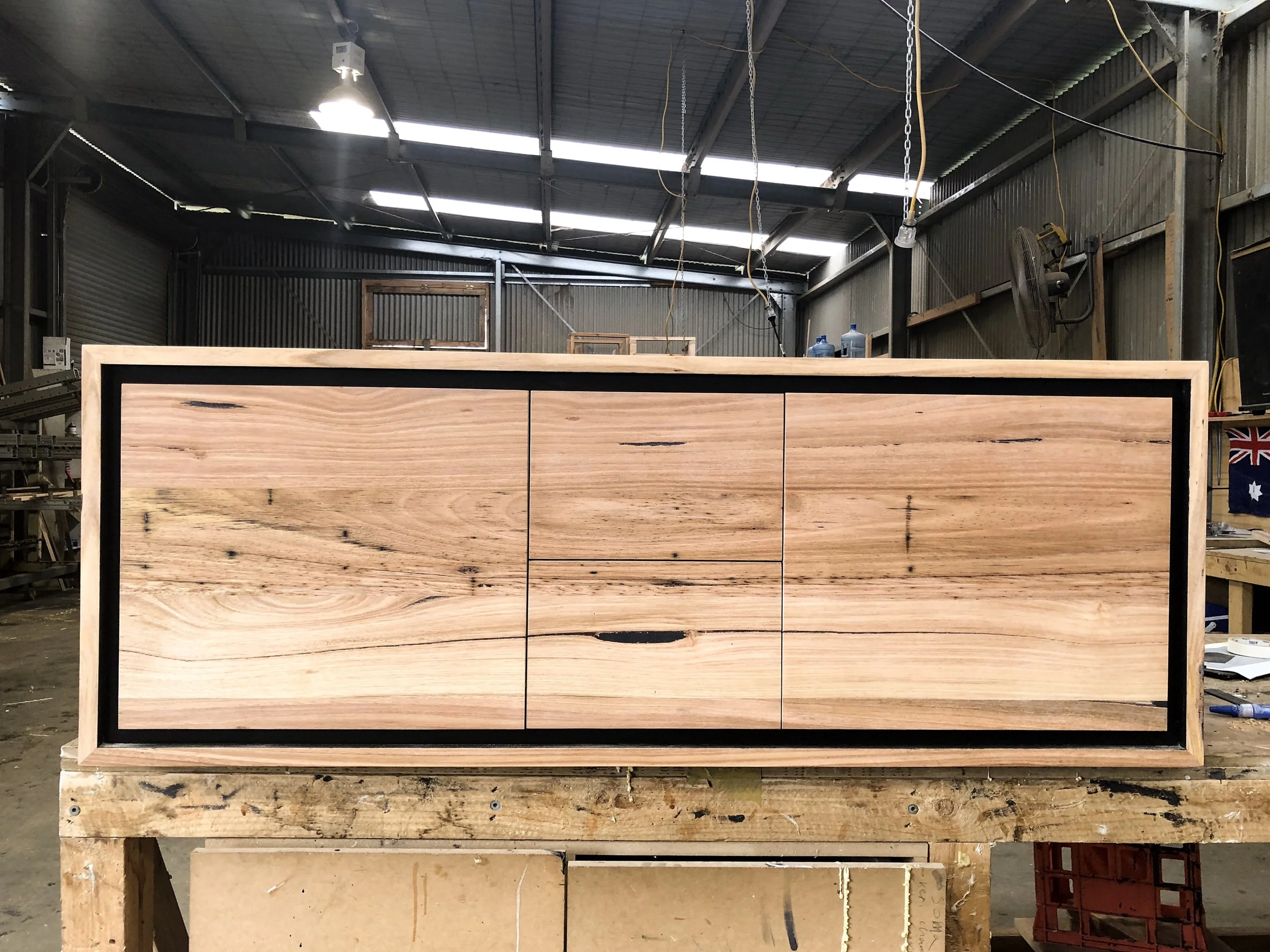 Wall hung timber vanity with black border