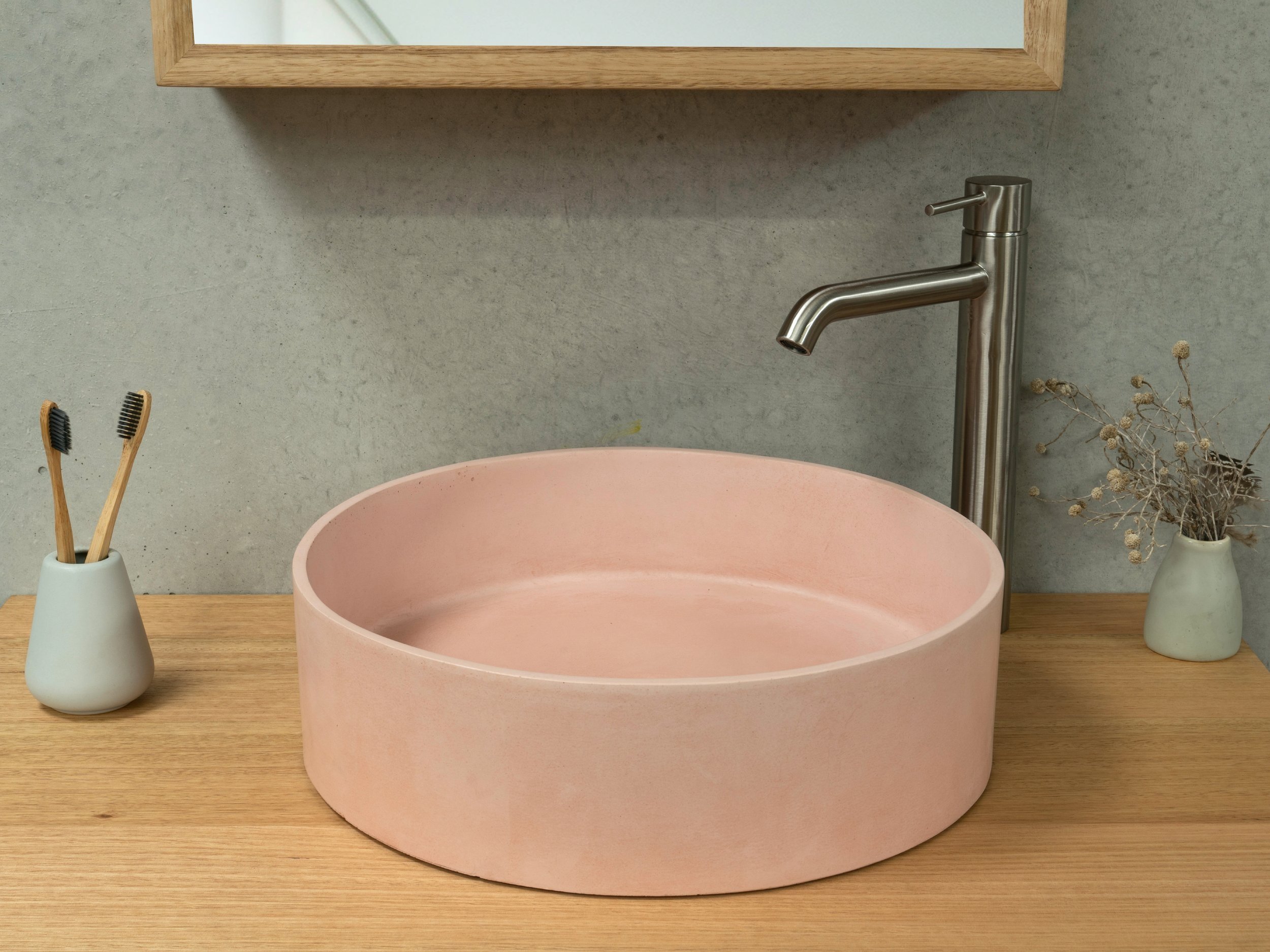 Pink concrete basin with timber vanity