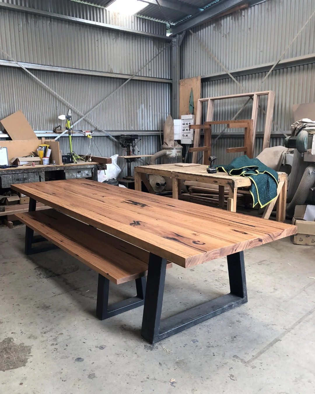 Crafted from some seriously stunning pieces of recycled Messmate timber, this custom Jarosite table includes a matching bench seat. With the chunky timber top rich in black sap lines, the angled black legs enhance the character whilst adding a modern