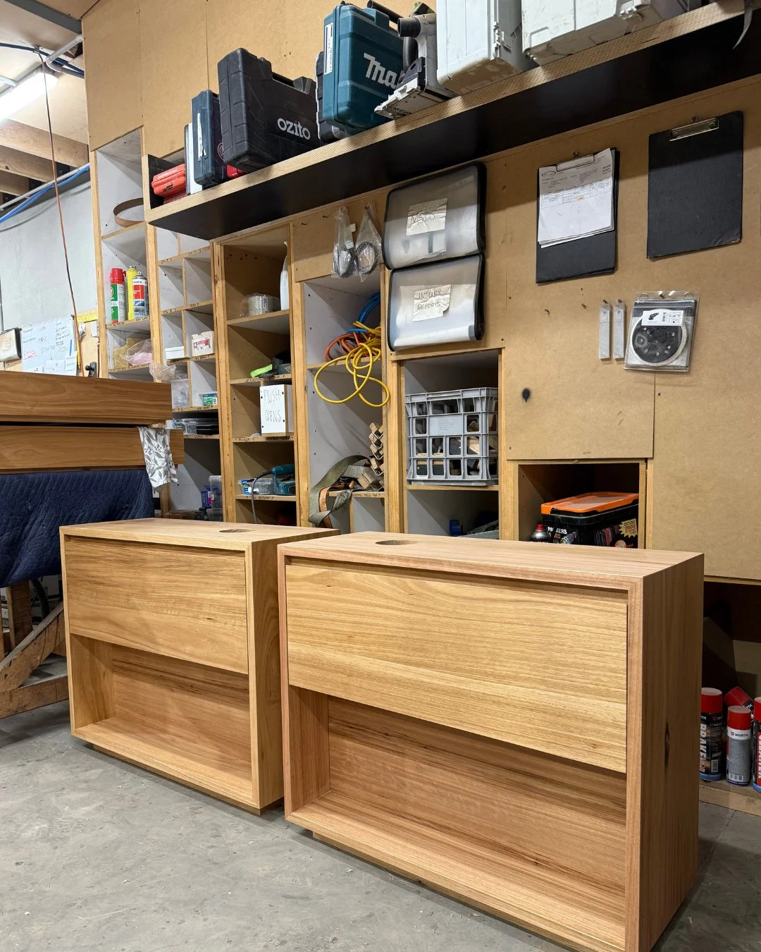 A couple of bespoke freestanding vanities with a single deep drawer and open shelving below. The fake panel at the back of the shelving hides the plumbing that comes up from the floor in our client's apartment. ⁠
⁠
Australian Chestnut timber was used