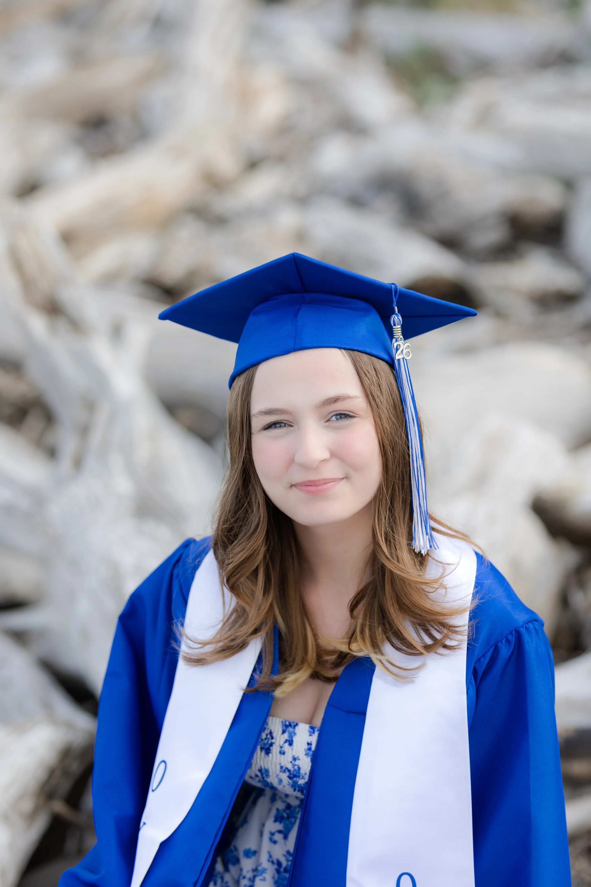 Cap and gown graduation picture in the driftwood in North Kitsap, WA