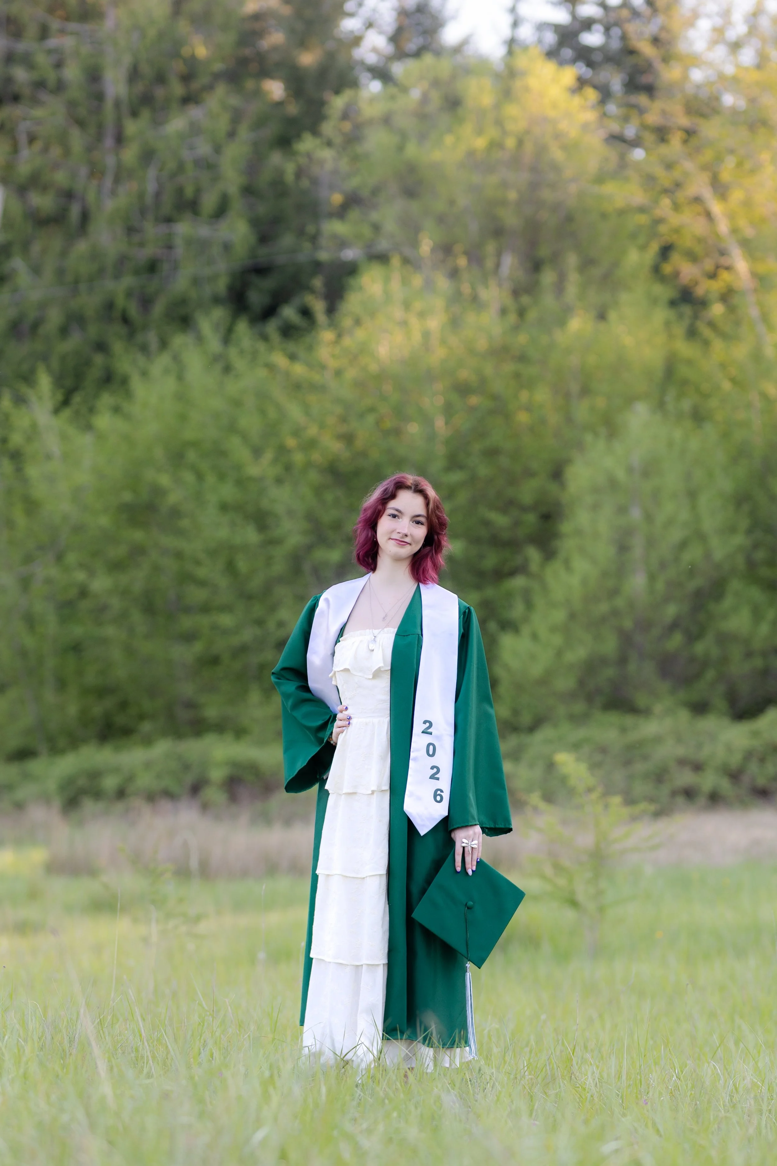 Peninsula High School graduation picture taken in a grassy field