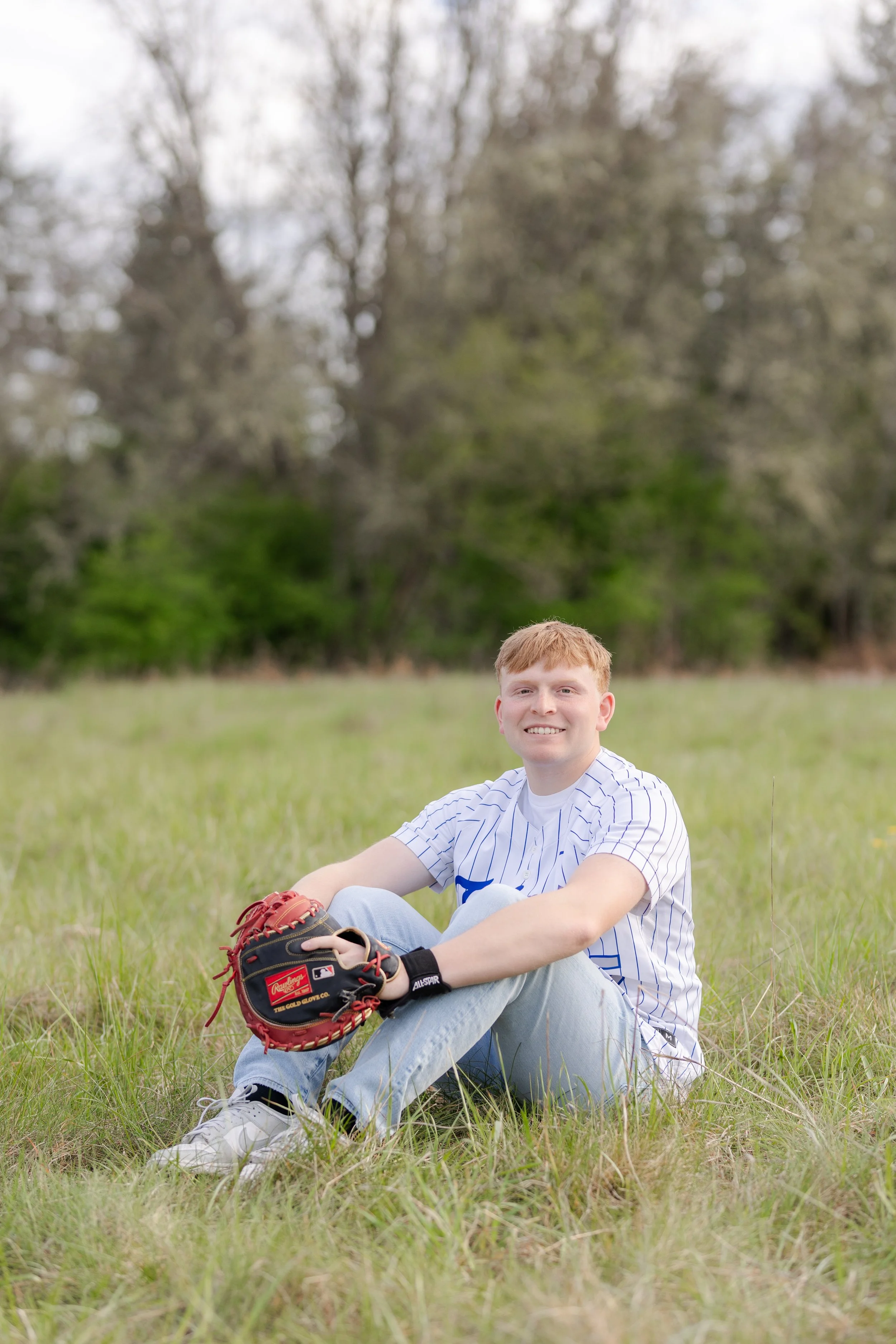Senior picture with baseball jersey and glove in Port Orchard, WA