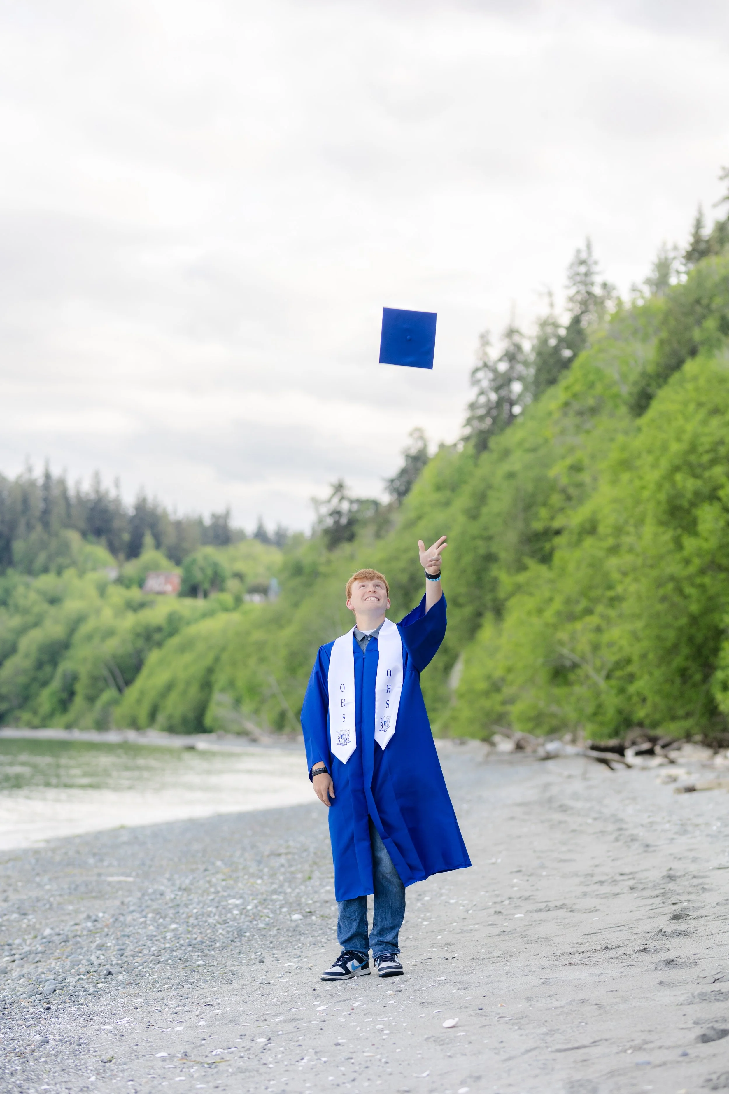 Olympic High School senior doing a cap toss for graduation picture