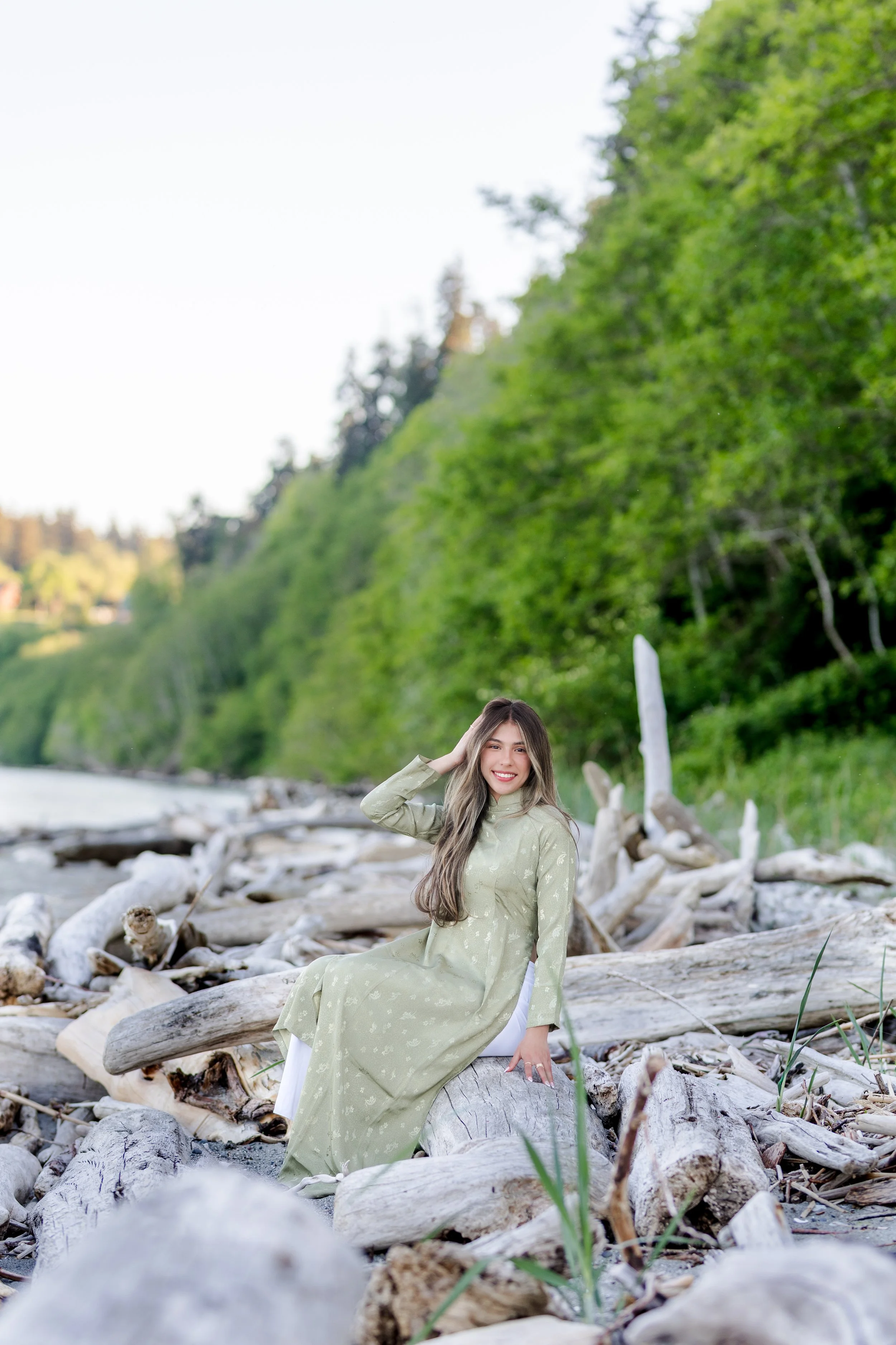 Senior picture taken at a Kitsap beach in a traditional Vietnamese dress