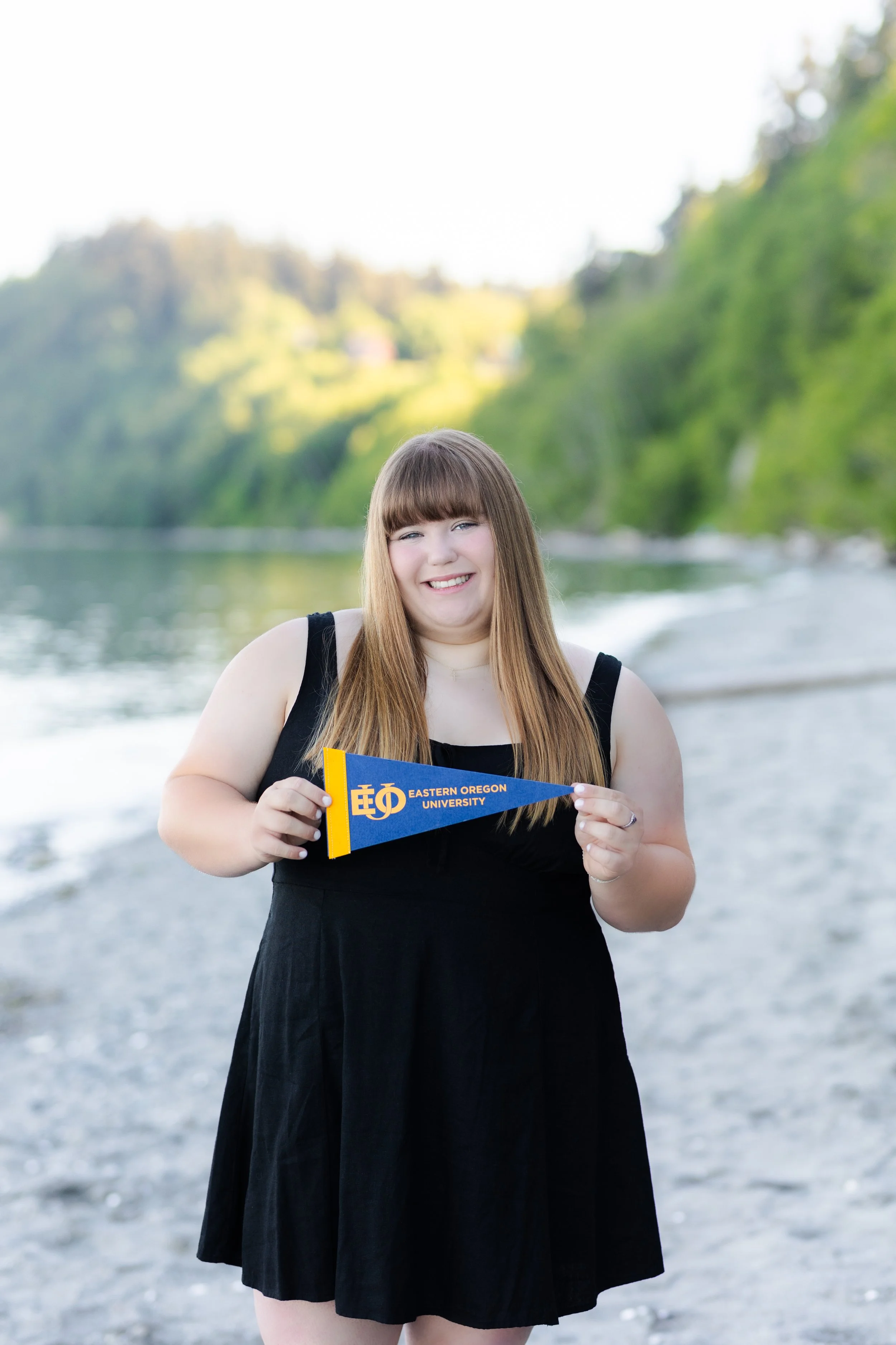 Kitsap college announcement photo of senior holding college pendant for Eastern Oregon University