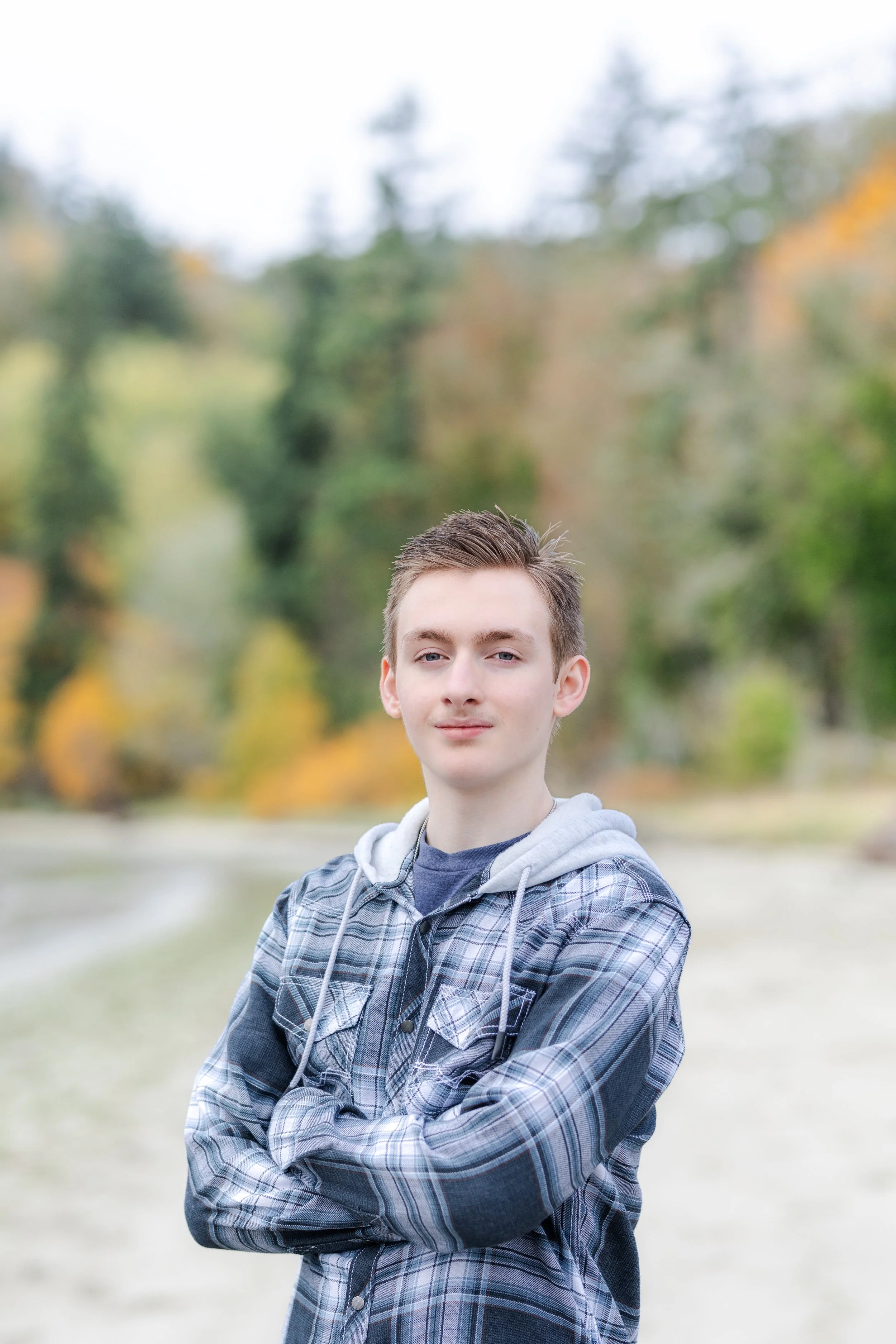 Kitsap fall senior photo taken on beach with fall colors in the background in Washington state