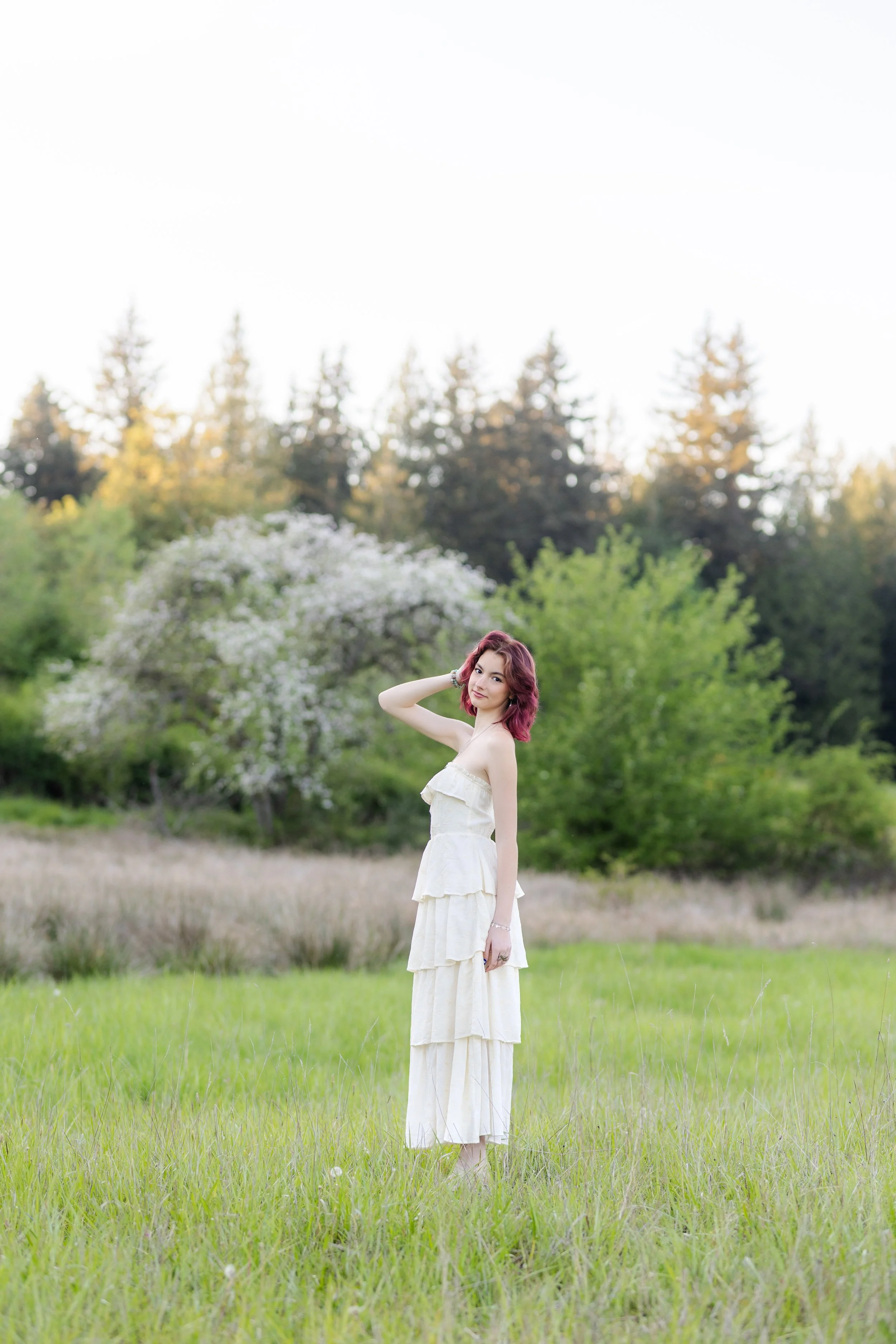 Senior picture of a Peninsula High School student in a grassy field