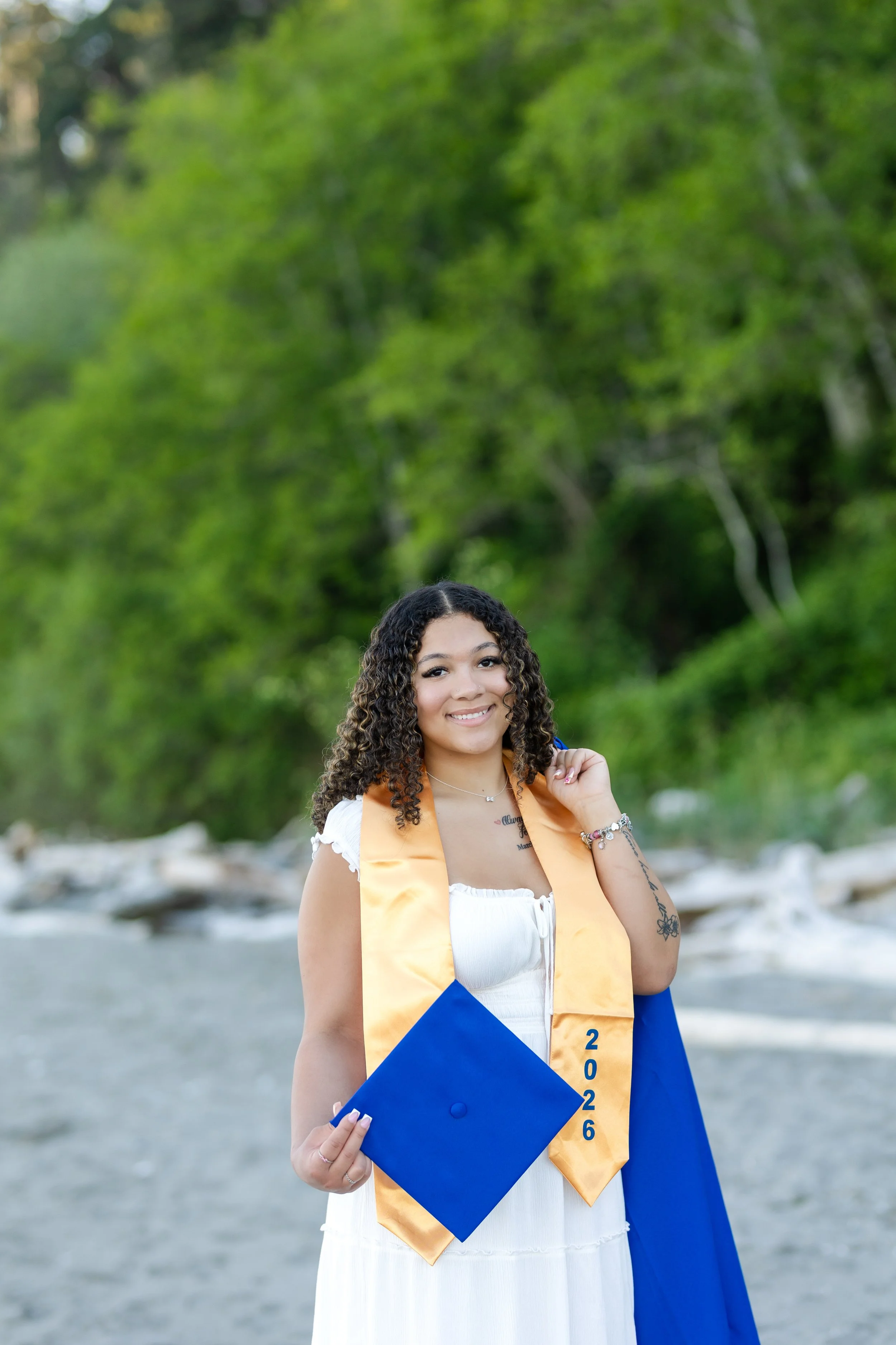 Cap and gown picture for a Stadium High School senior taken on the beach