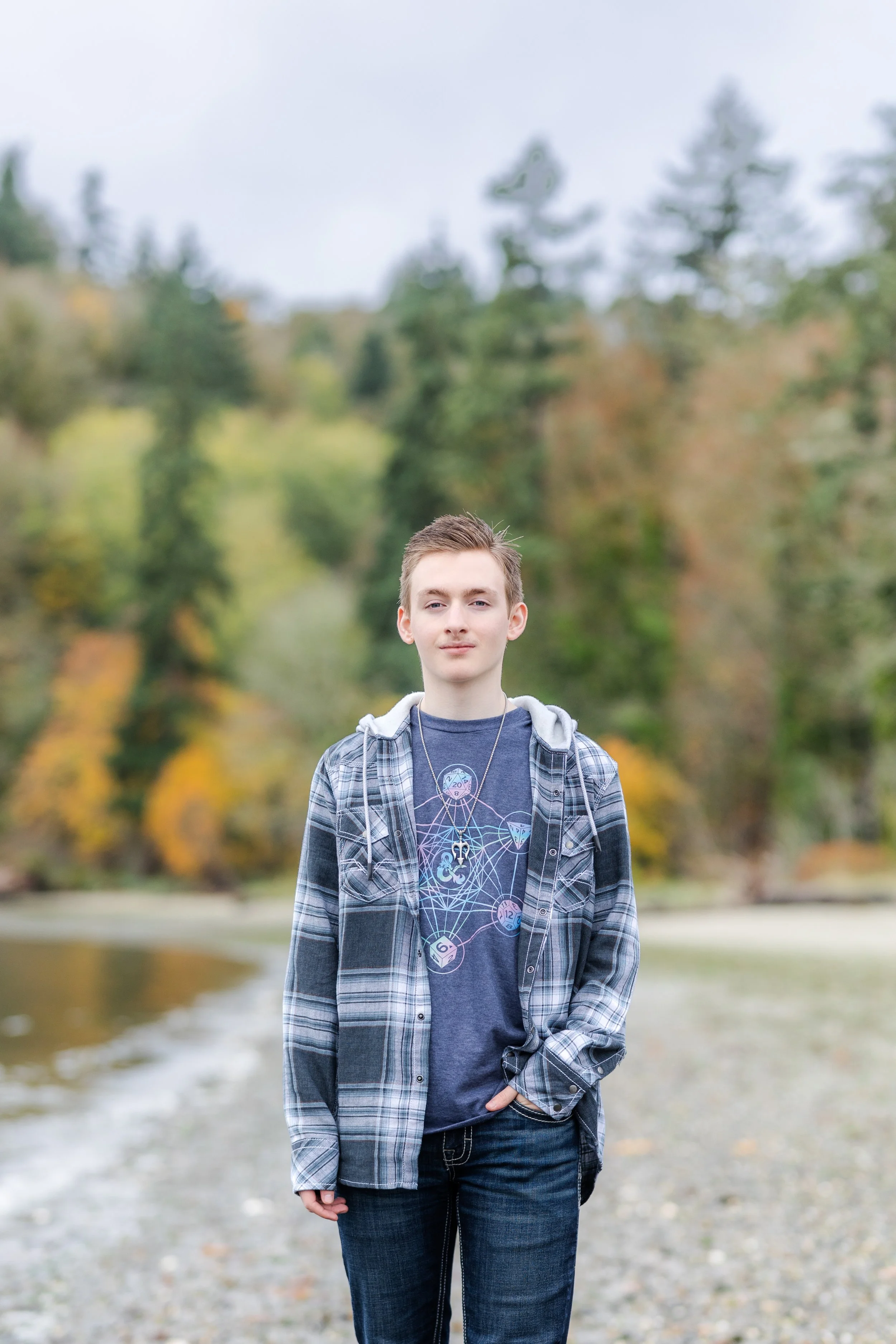 Senior picture of boy in Washington walking on a beach in the fall