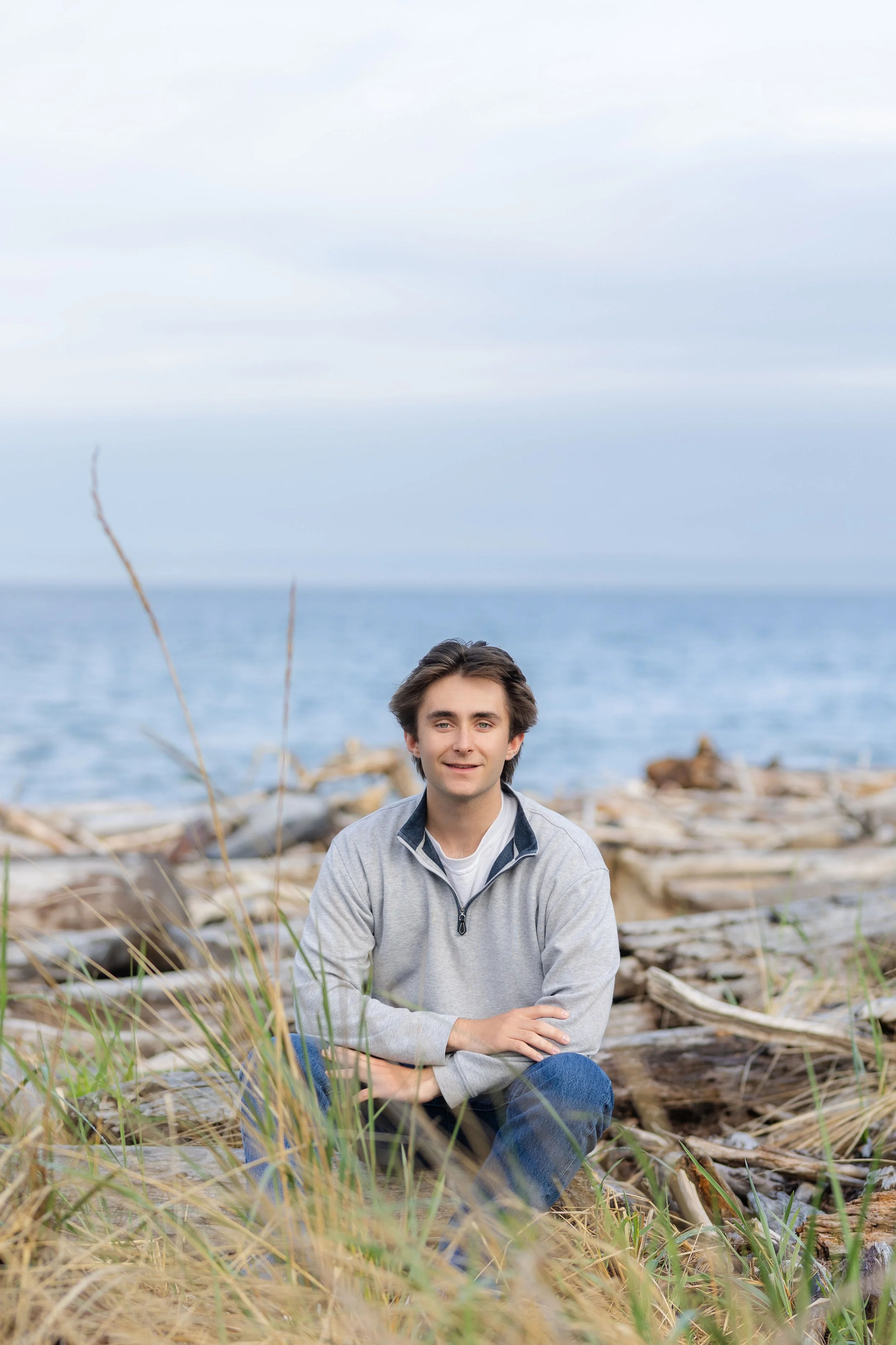Senior picture taken near Kingston, WA on a beach with driftwood