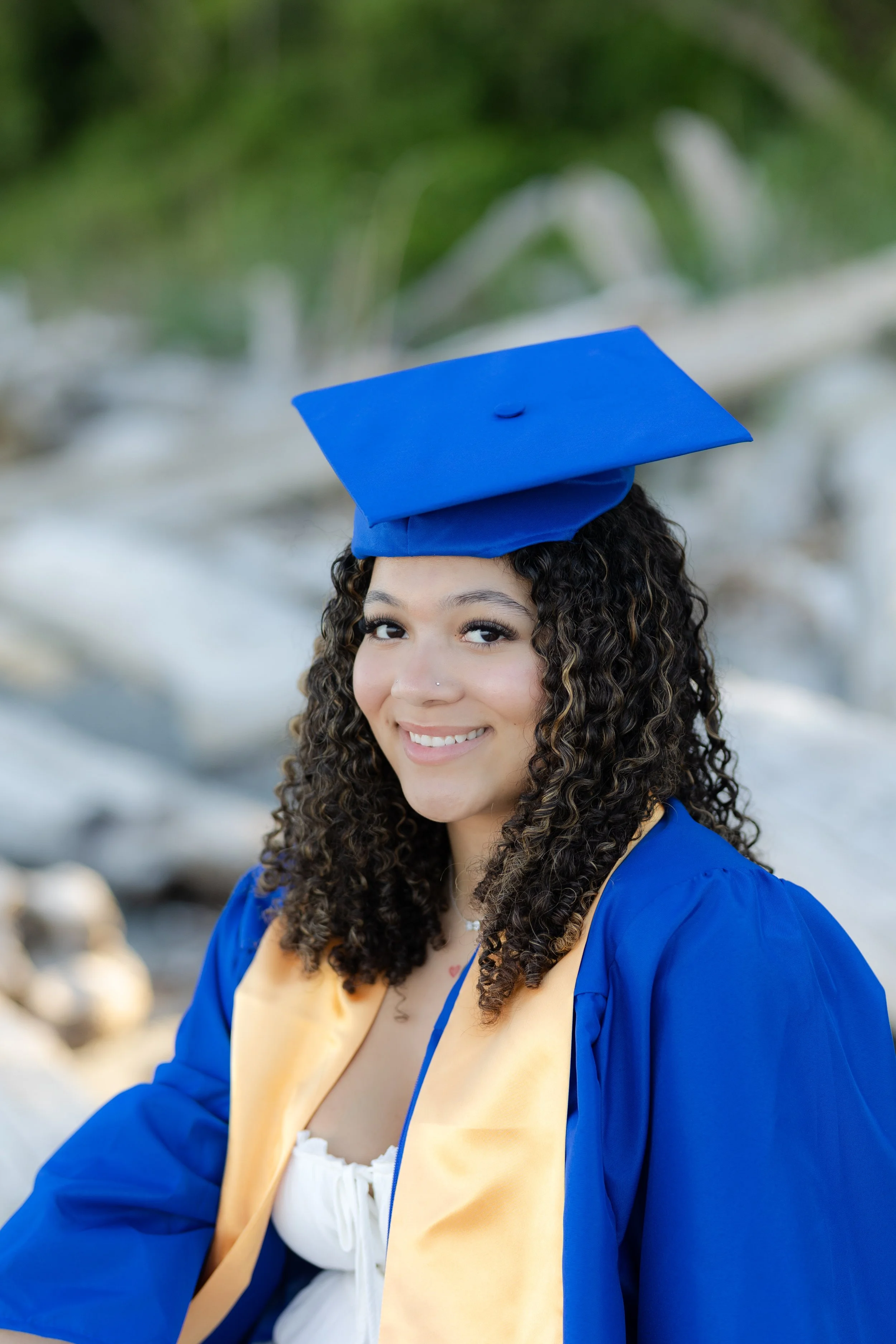Cap and gown photo in the driftwood on a Kitsap beach