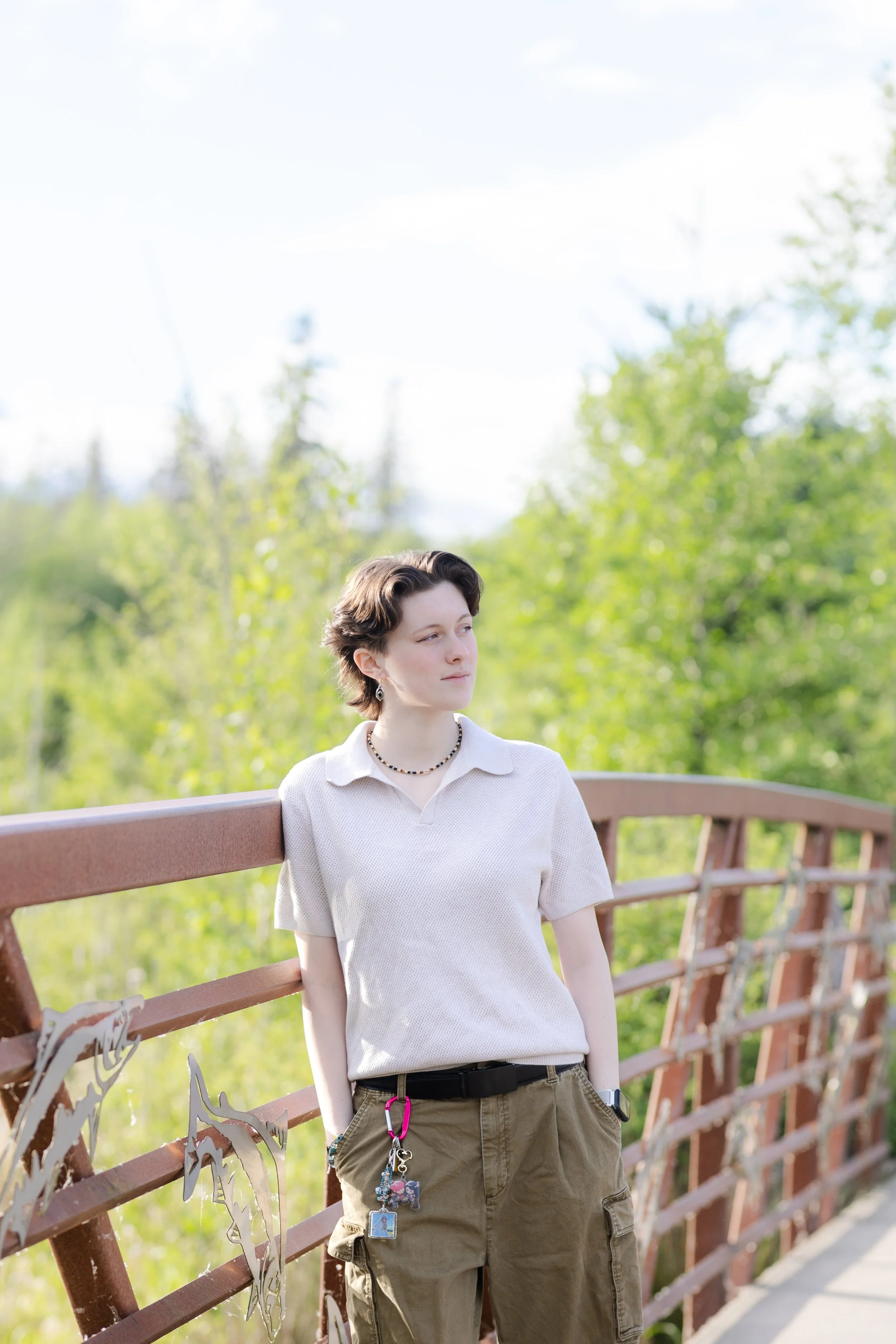 Silverdale senior picture of a girl leaning against a metal bridge