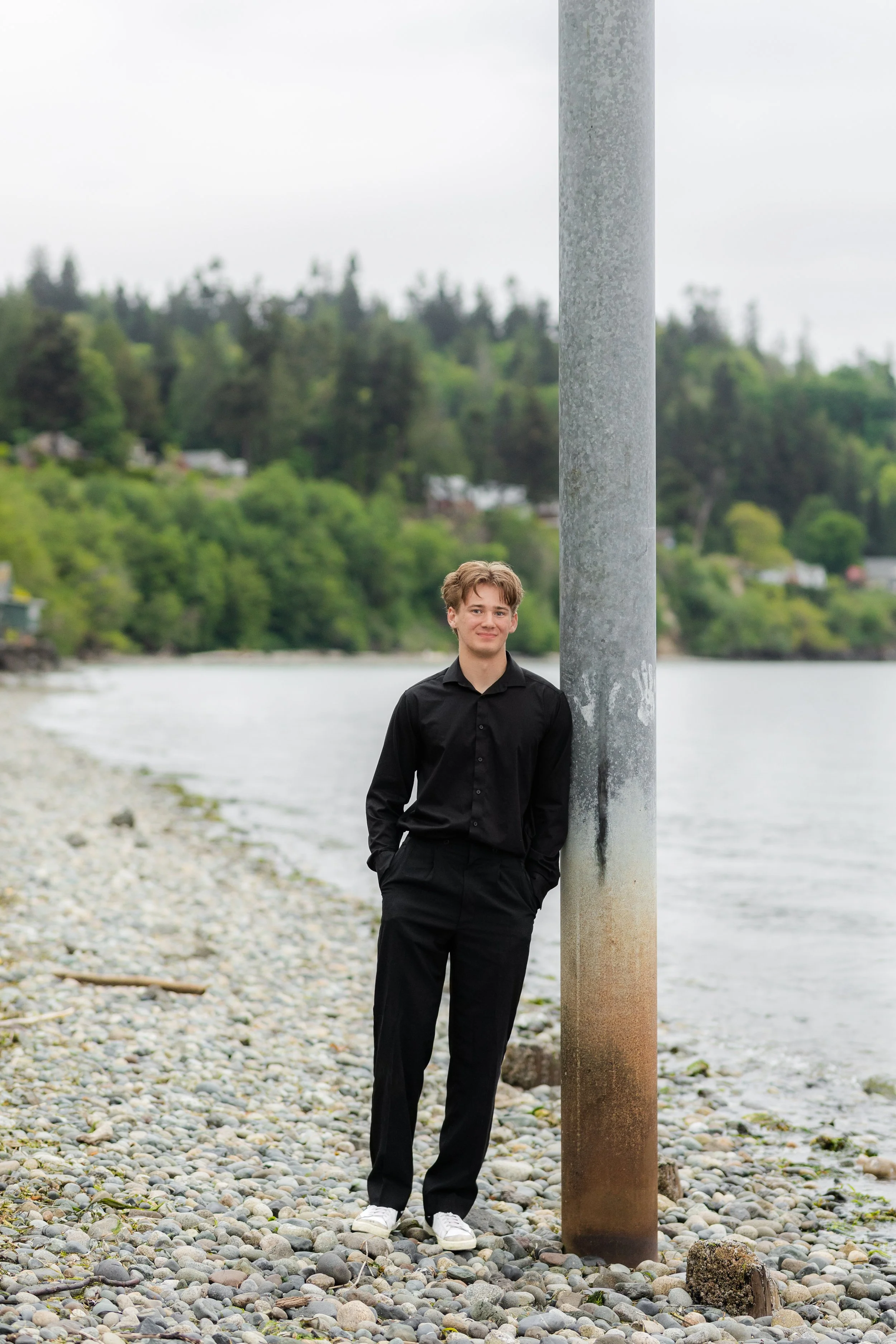 Kitsap senior picture of a senior leaning against support pole for pier