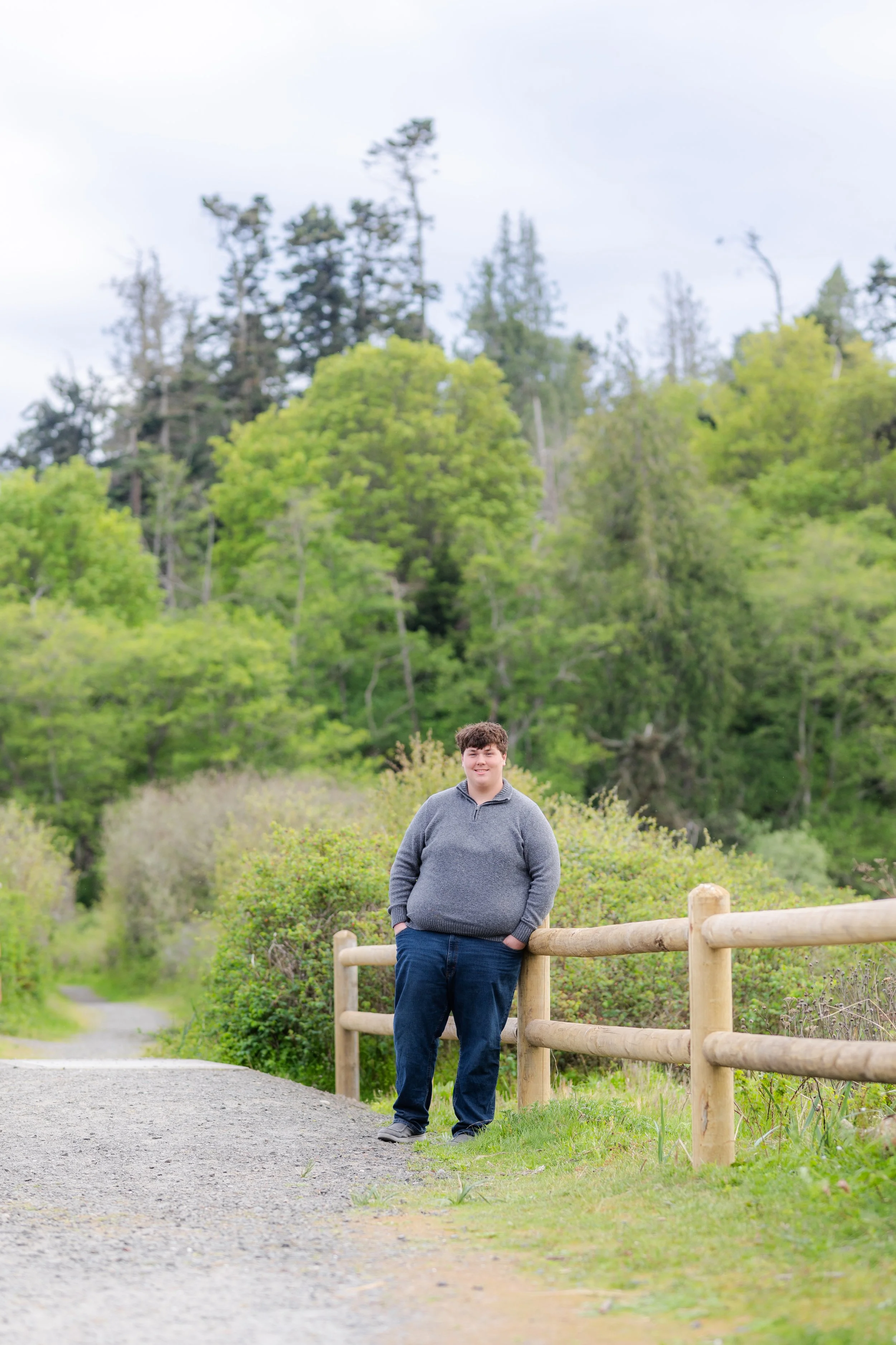 North Kitsap senior picture taken of a boy against a fence in the spring