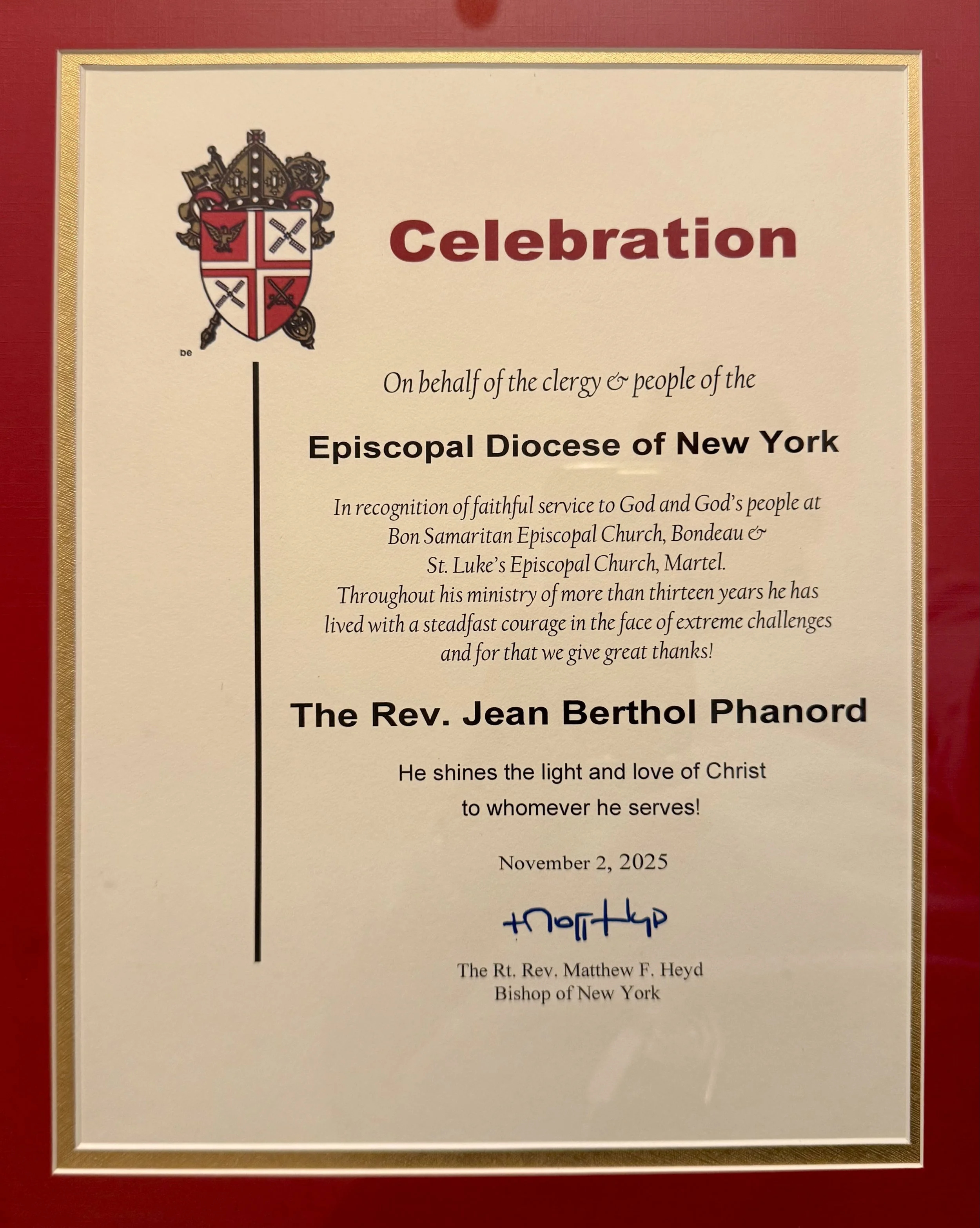 Bishop Matthew Heyd awarded this certificate to Fr. Jean Berthol Phanord.