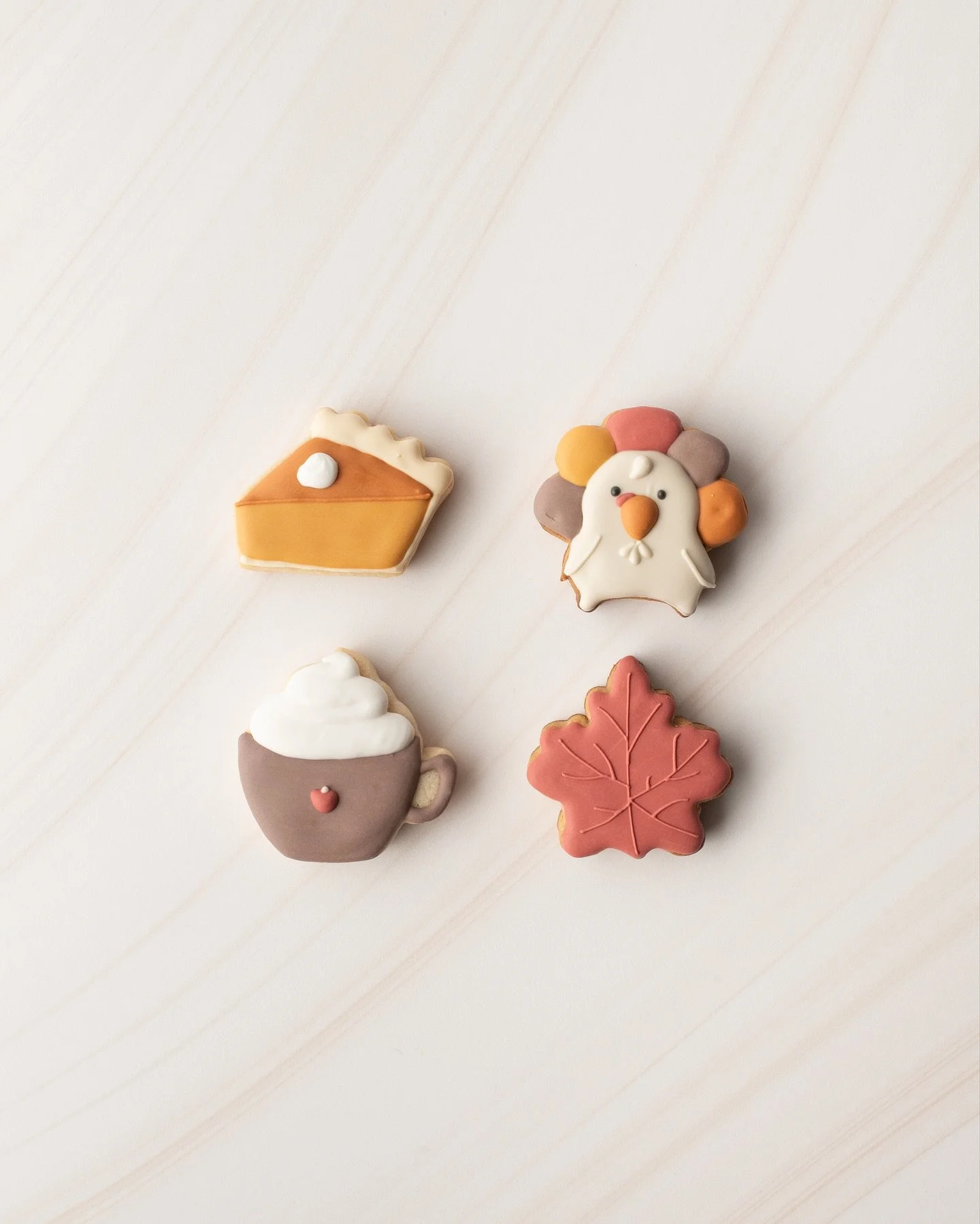 Thanksgiving 2025 Sneak Peek 1 of 4: Fall Minis

This set of 4 fall cuties (approx 2&rdquo;) consist of 3 different delicious flavors - Vanilla Bean, Pumpkin Spice, and Spiced Apple Cider (brand NEW). Each cookie is paired with Vanilla royal icing an