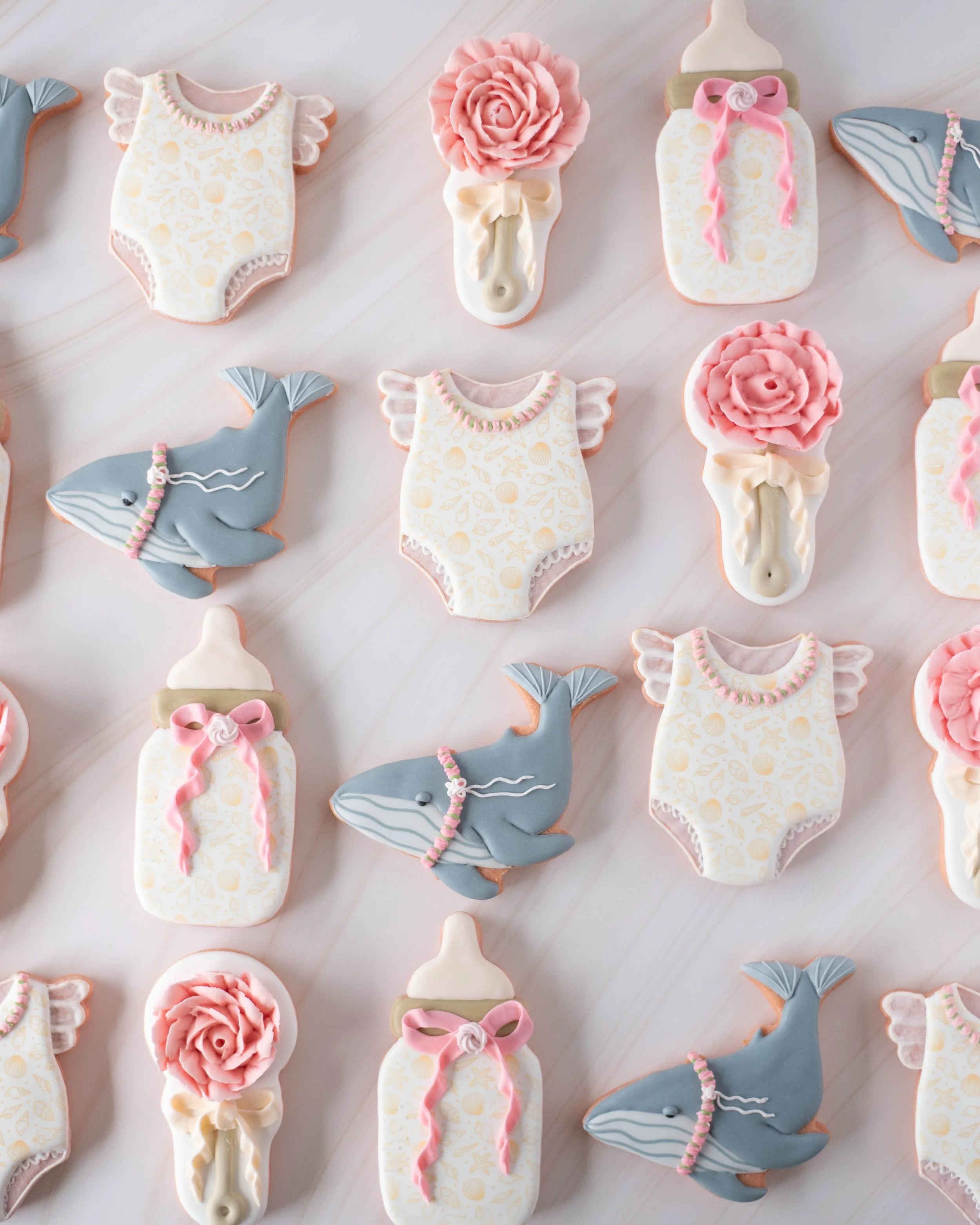 This set was so fun to design and make🤗. As requested by the customer, the designs include hints as to the baby&rsquo;s name. Such a fun way to reveal her beautiful name ❤️.

Flavor: Strawberry Lemonade cookie with Lemon royal icing