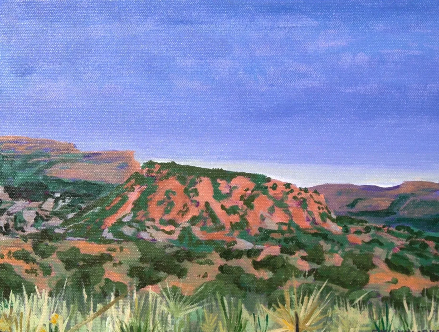 A landscape painting of rolling hills with a sunset-hued sky.