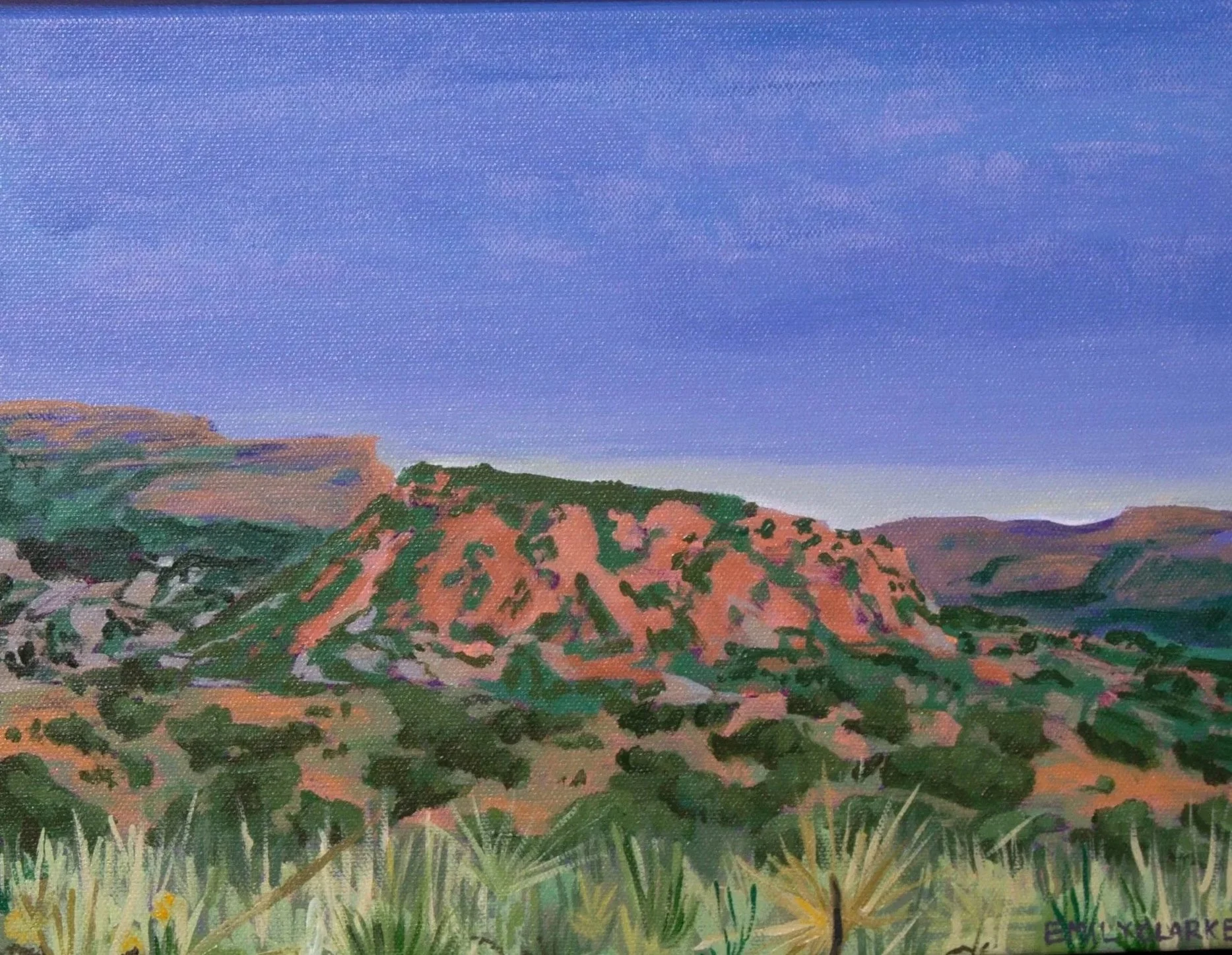 A landscape painting of rolling hills with a sunset-hued sky.