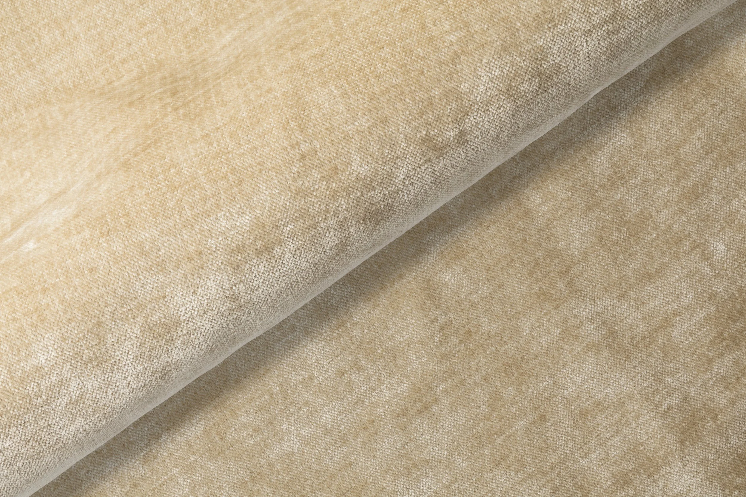 Närbild av beige tygmaterial med fin textur.