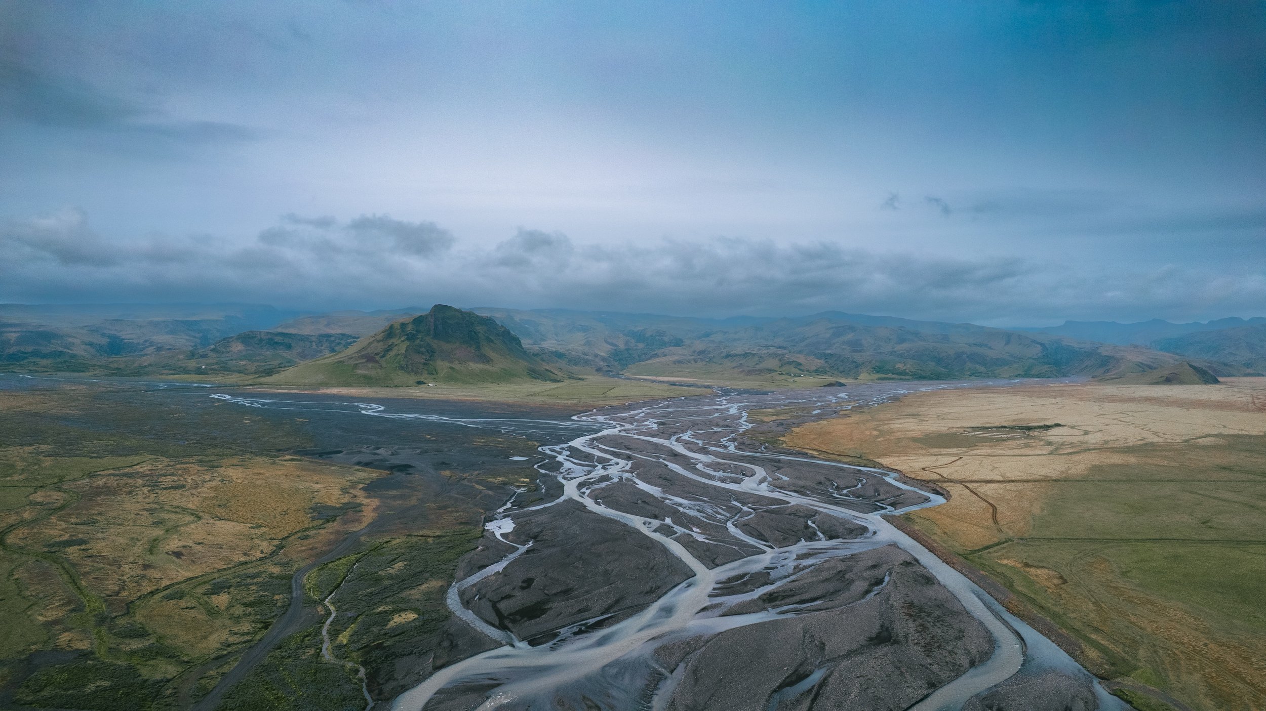 Black sand run-off from Huldujökull which is behind the mountains in the background