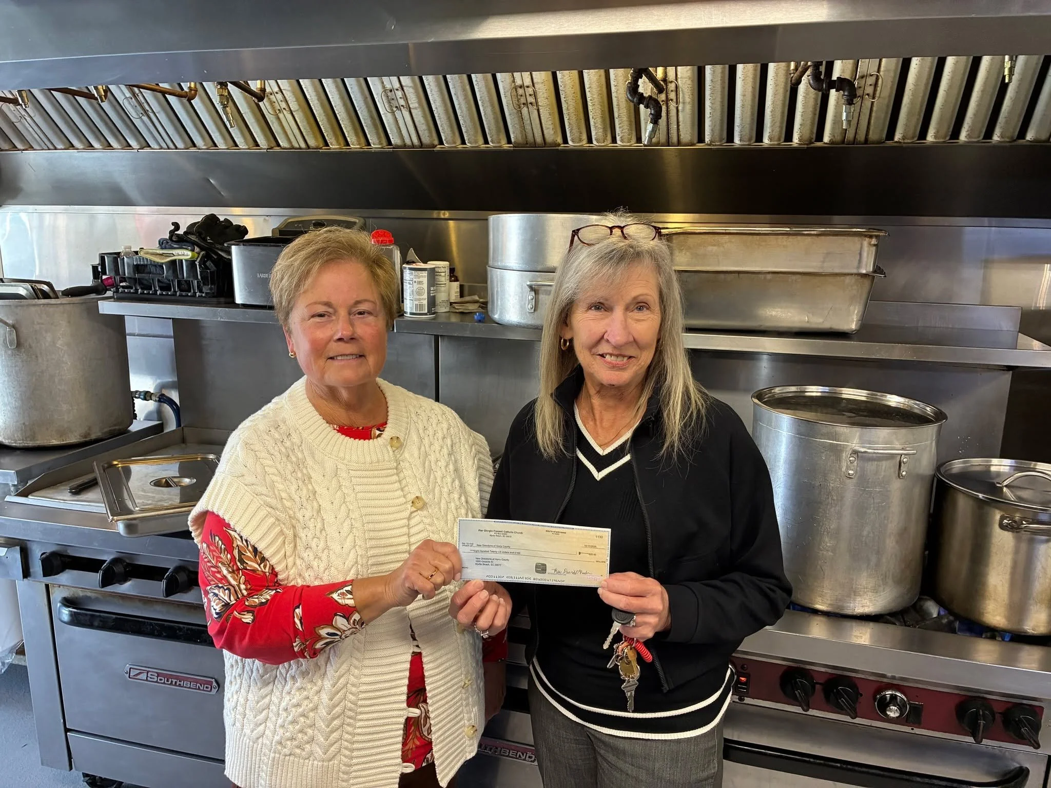 This week, Phyllis Phillips (pictured left, Kathy Jenkins, New Directions CEO, pictured right) represented Pier Giorgio Frassati Catholic Church in donating $820 from Sunday’s collection. Each week, their church sets aside 10% to share among se