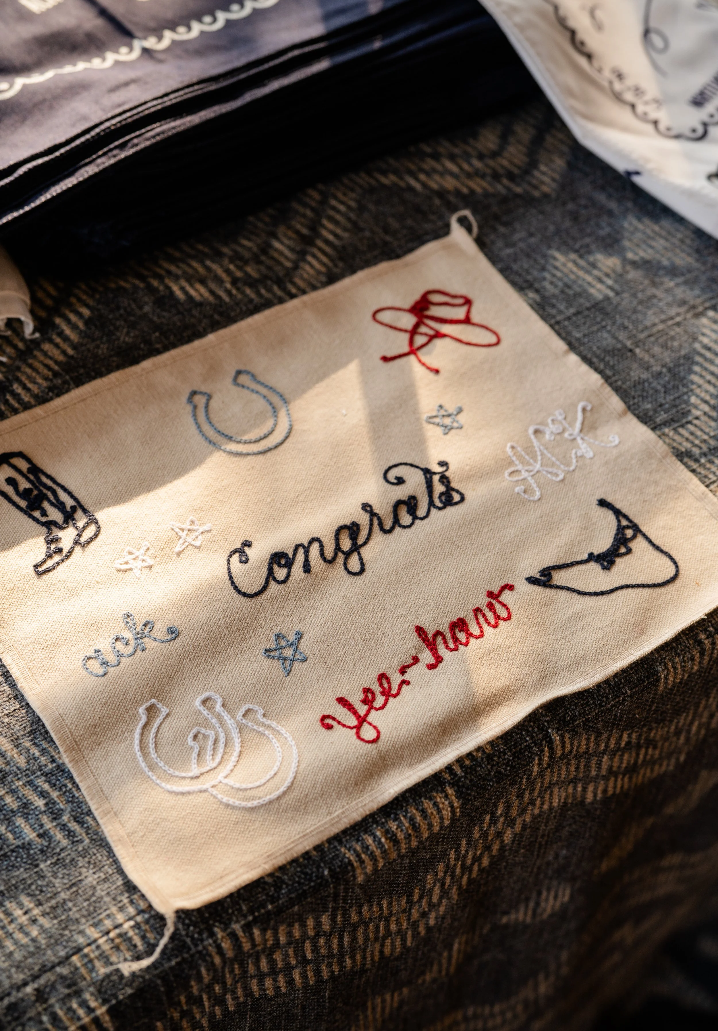 A custom embroidery flash design sheet featuring ACK, ack, two horseshoes, Yee-haw, a cowboy boot, cowboy hat, stars, and the outline of Nantucket.