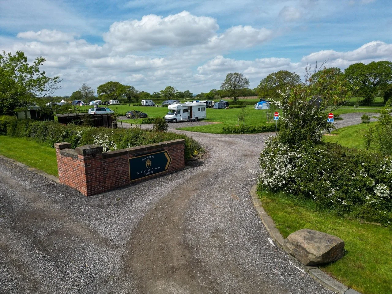 Spacious hardstanding and grass touring pitches with electric hook-up points at Oakwood Campsite, close to Oulton Park race track.