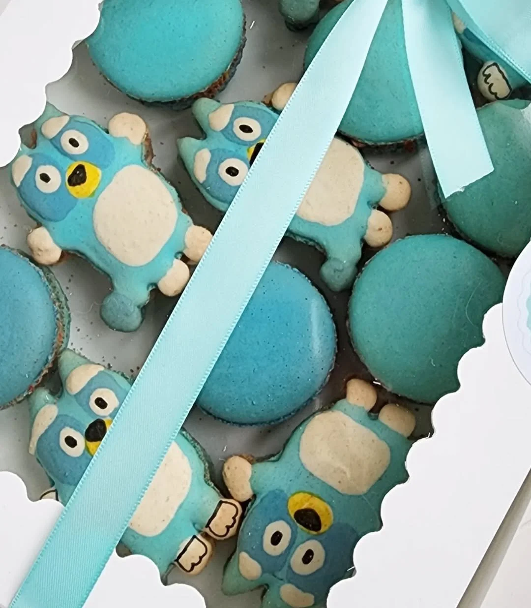 Specialty macarons featuring a Bluey cartoon character theme for a kid's birthday party.