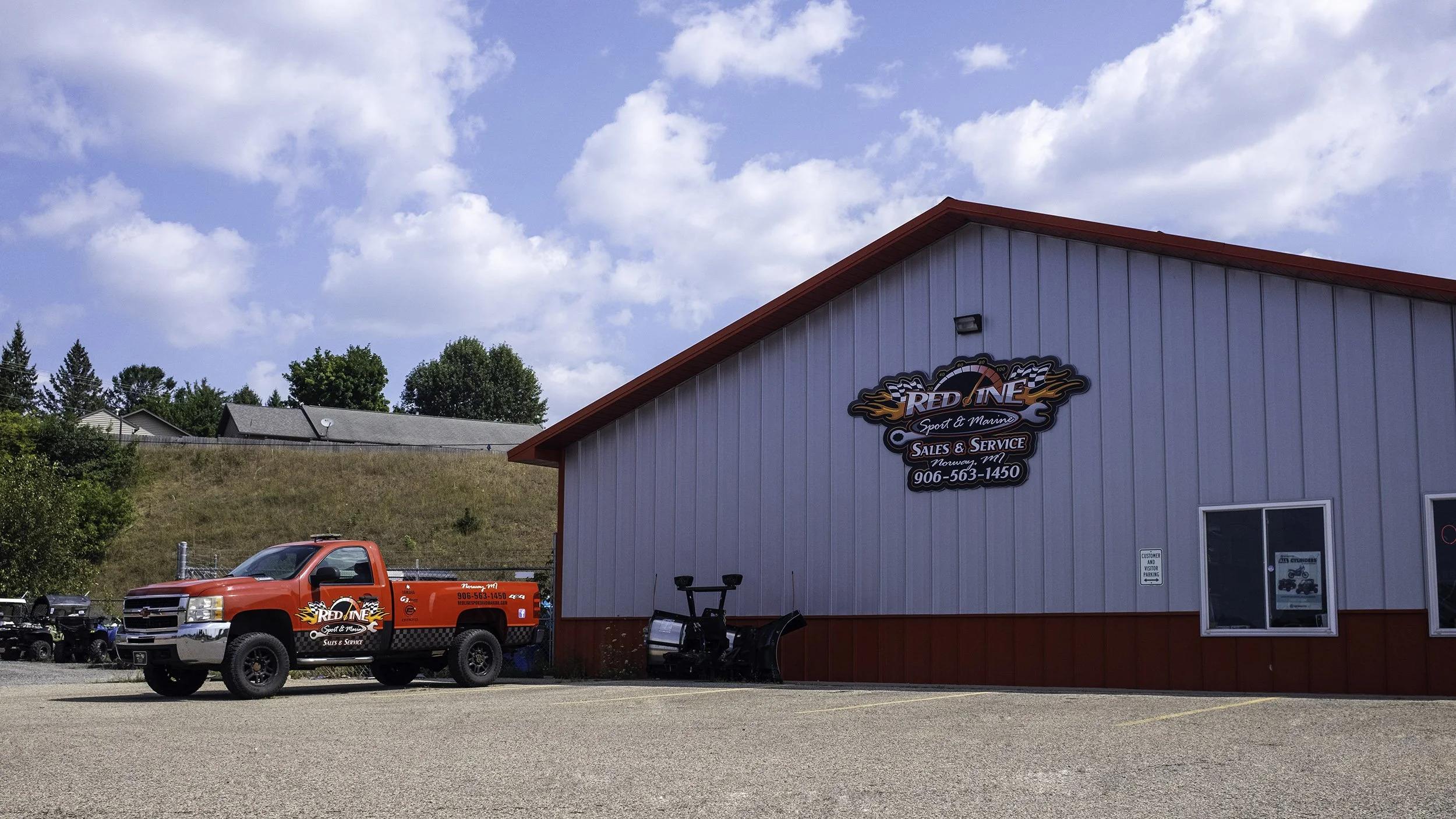 Redline Sport & Marine exterior with red service truck