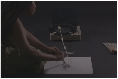 Mimi Koku
I heard a sound that carries.  
Crosses planes, a sonic wave kinetic and potential.  
An ancient divination.  
I wander, dance along its coils in search of mothers’ gardens.  
With body, breath and voice to move - 
Polyrhythms, circles turn