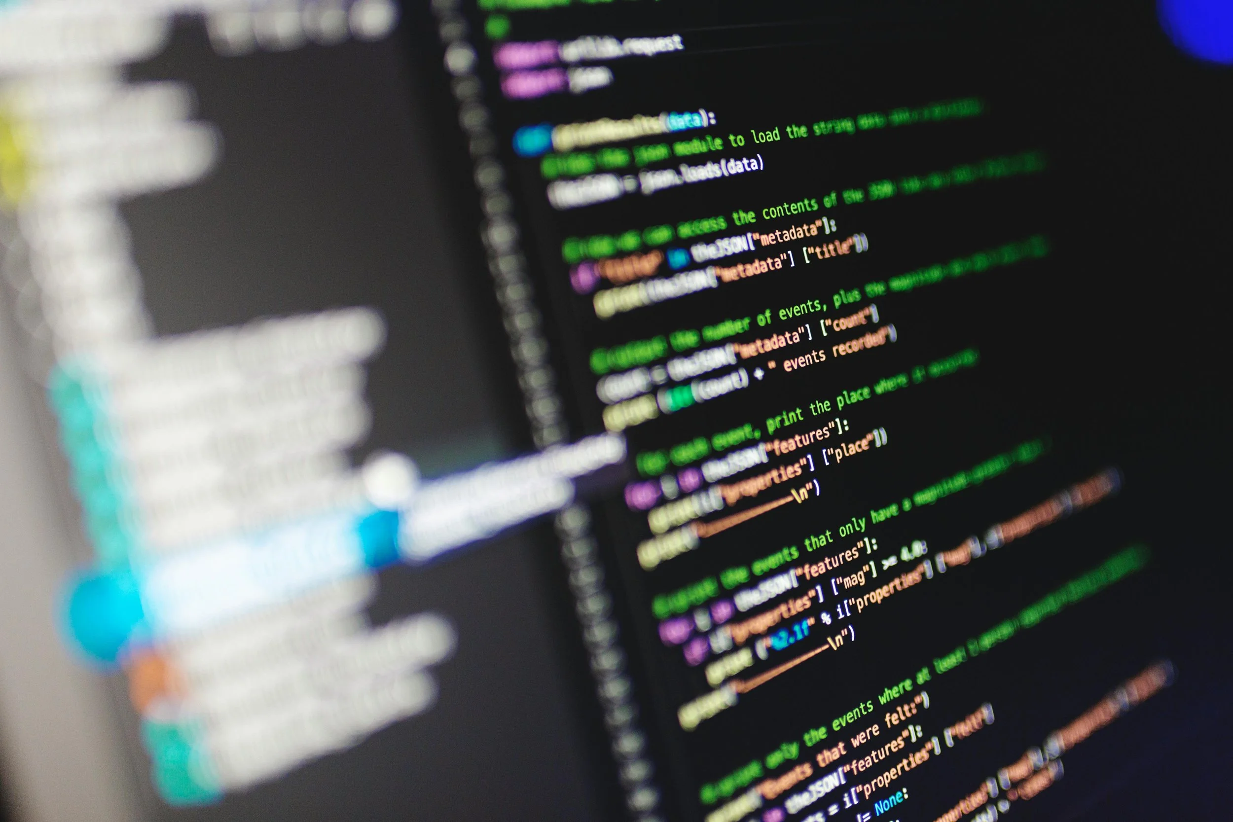 Computer screen displaying lines of color-coded programming code.