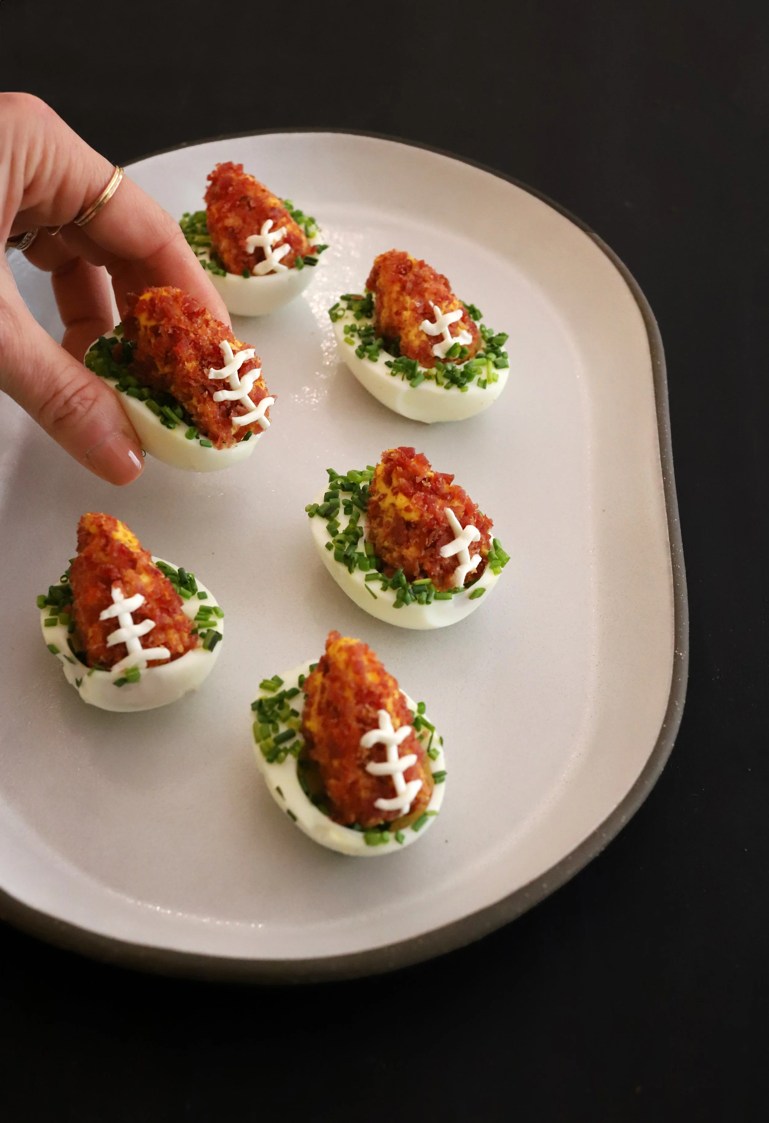 FOOTBALL-SHAPED DEVILED EGGS WITH TURKEY BACON CRUST &amp; CHIVE “FIELD”