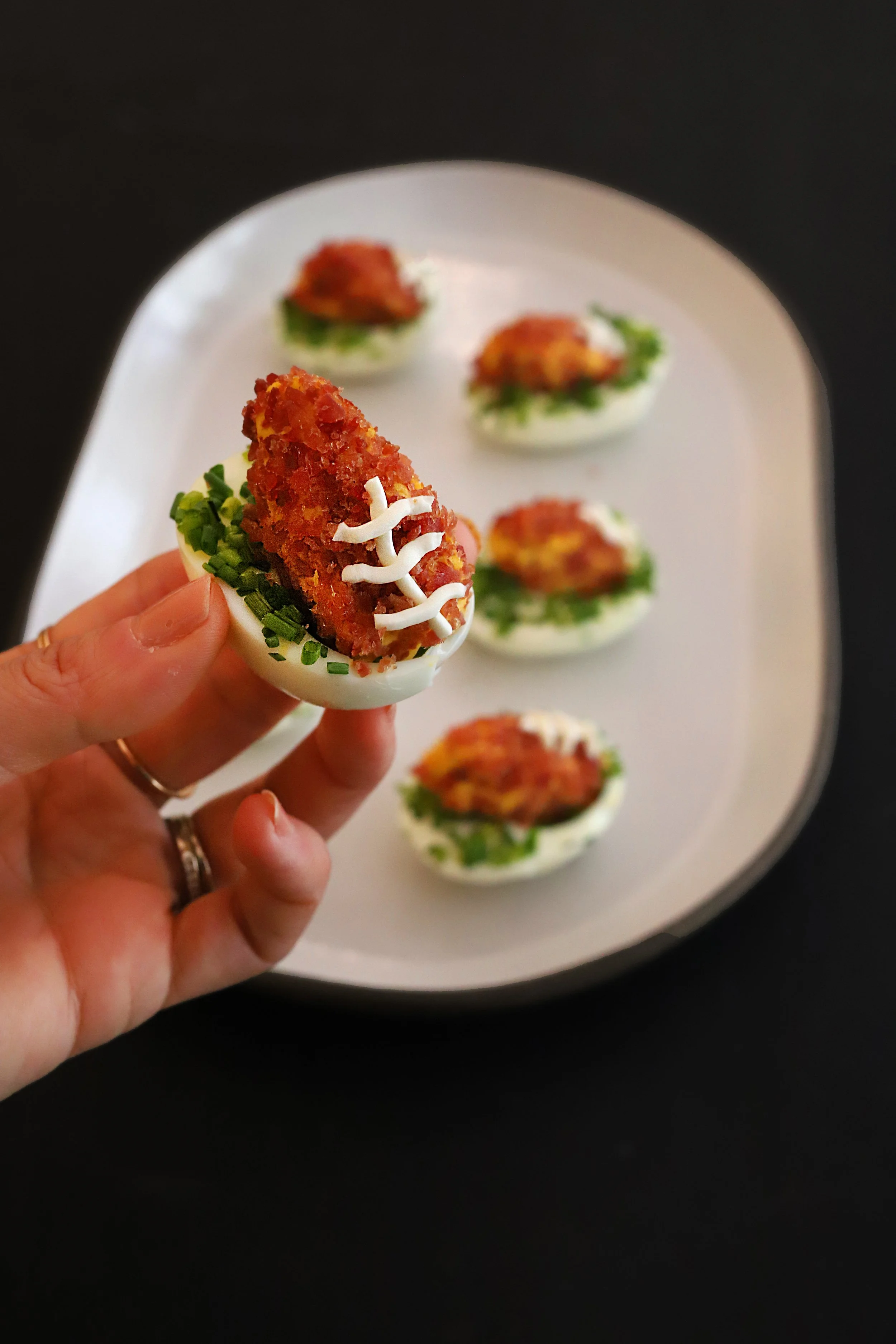 FOOTBALL-SHAPED DEVILED EGGS WITH TURKEY BACON CRUST &amp; CHIVE “FIELD”