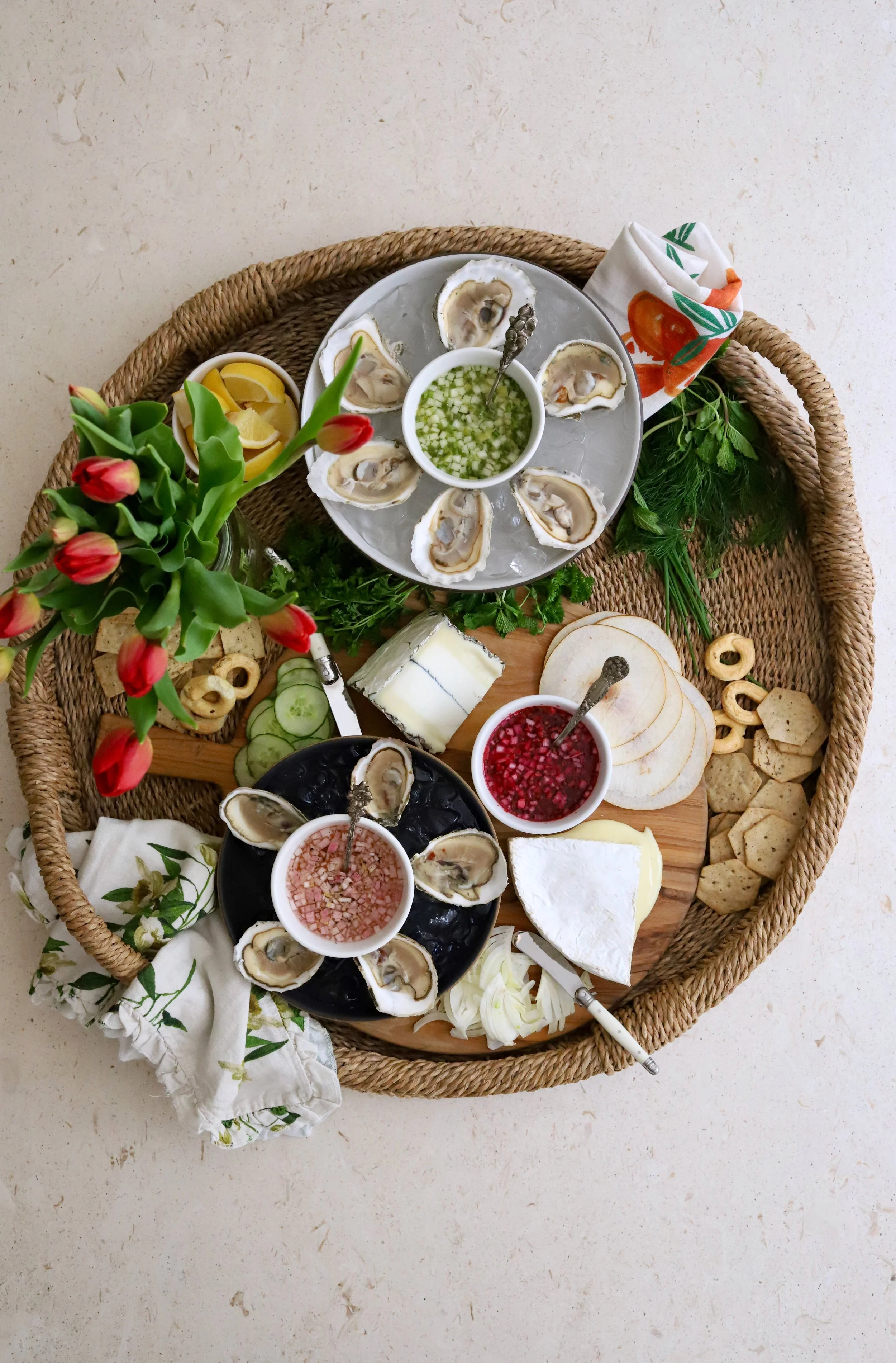 Spring oyster cheeseboard combined with fresh produce.